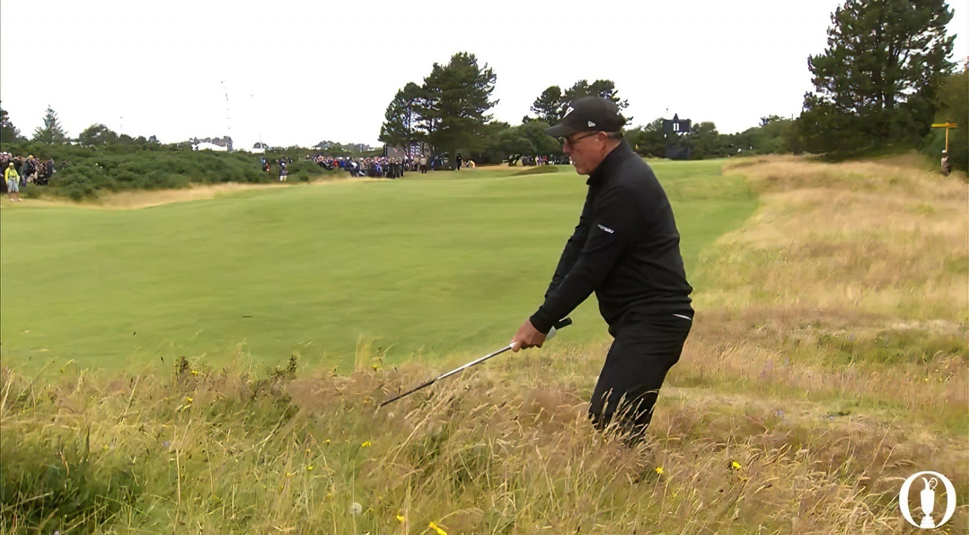 Phil Mickelson makes a par from a challenging lie at the 2024 Open Championship. Image via X @TheOpen