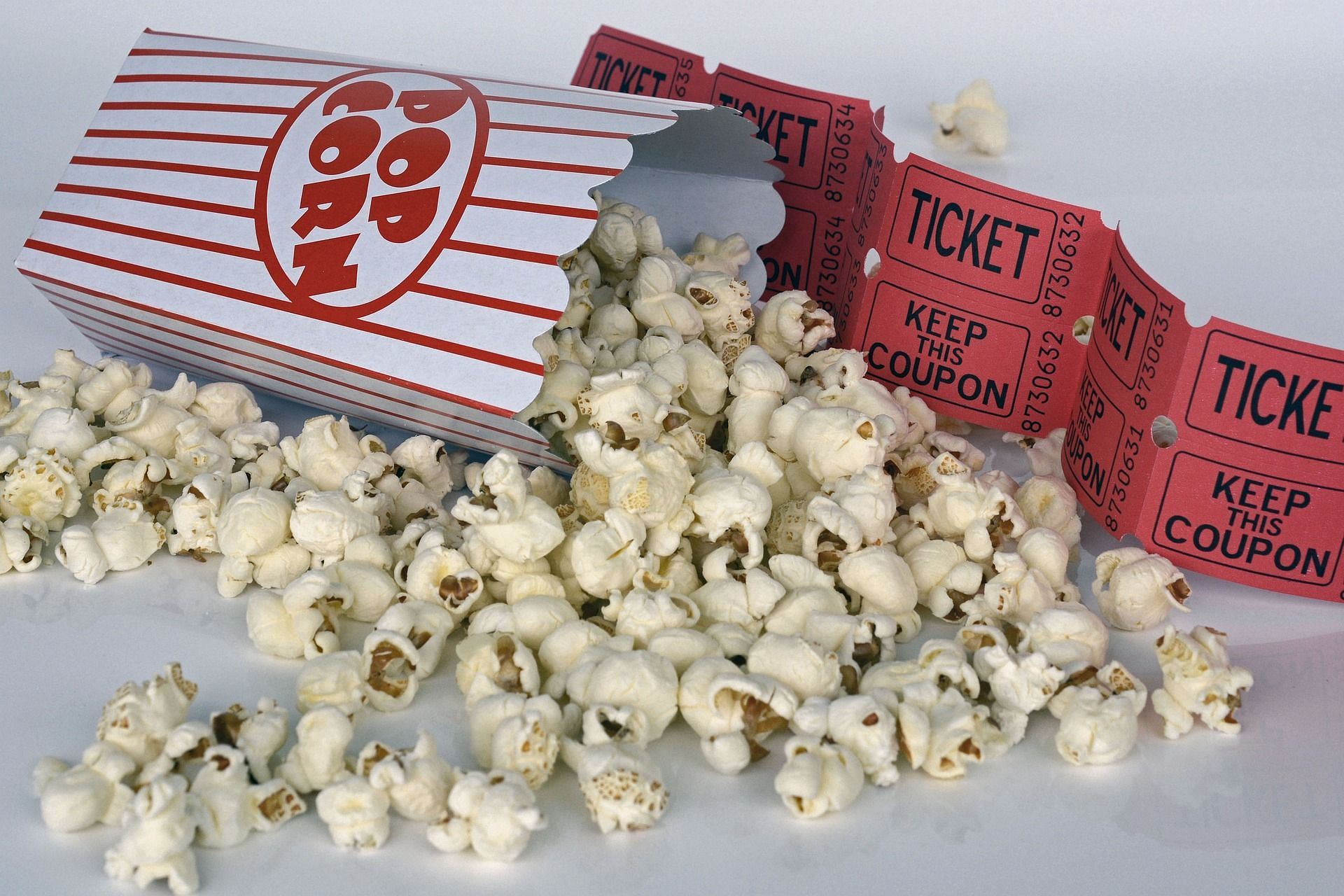 A representative image of a movie ticket and popcorn. (Image via Pixabay)