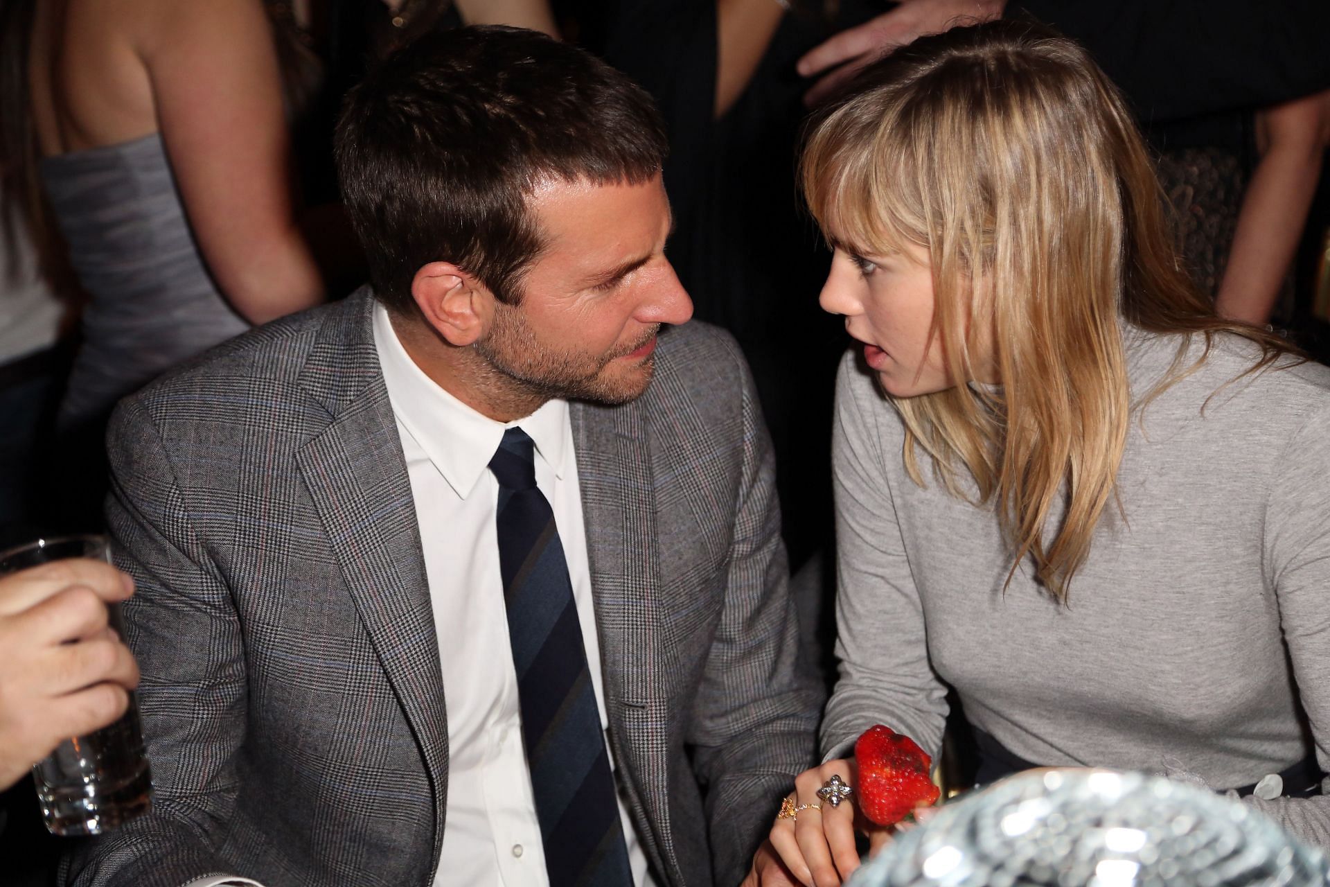 Bradley Cooper (L) and Suki Waterhouse attend Grey Goose Vodka in 2013 (Image via Getty Images)