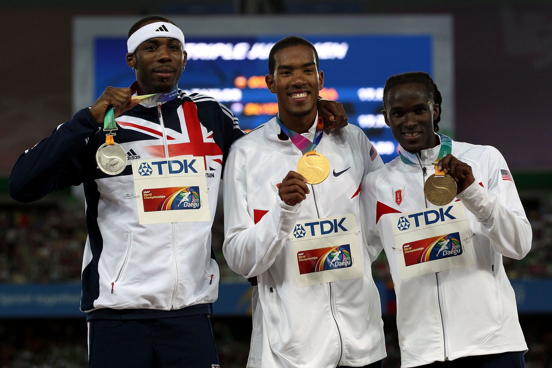 Christian Taylor [C] with the gold medal at the 2011 IAAF World Championships [Image Source: Getty]