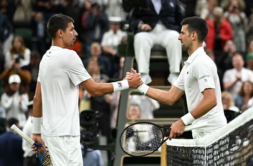 Alexei Popyrin (L) and Novak Djokovic (R) shake hands after their third-round match at the 2024 Wimbledon Championships