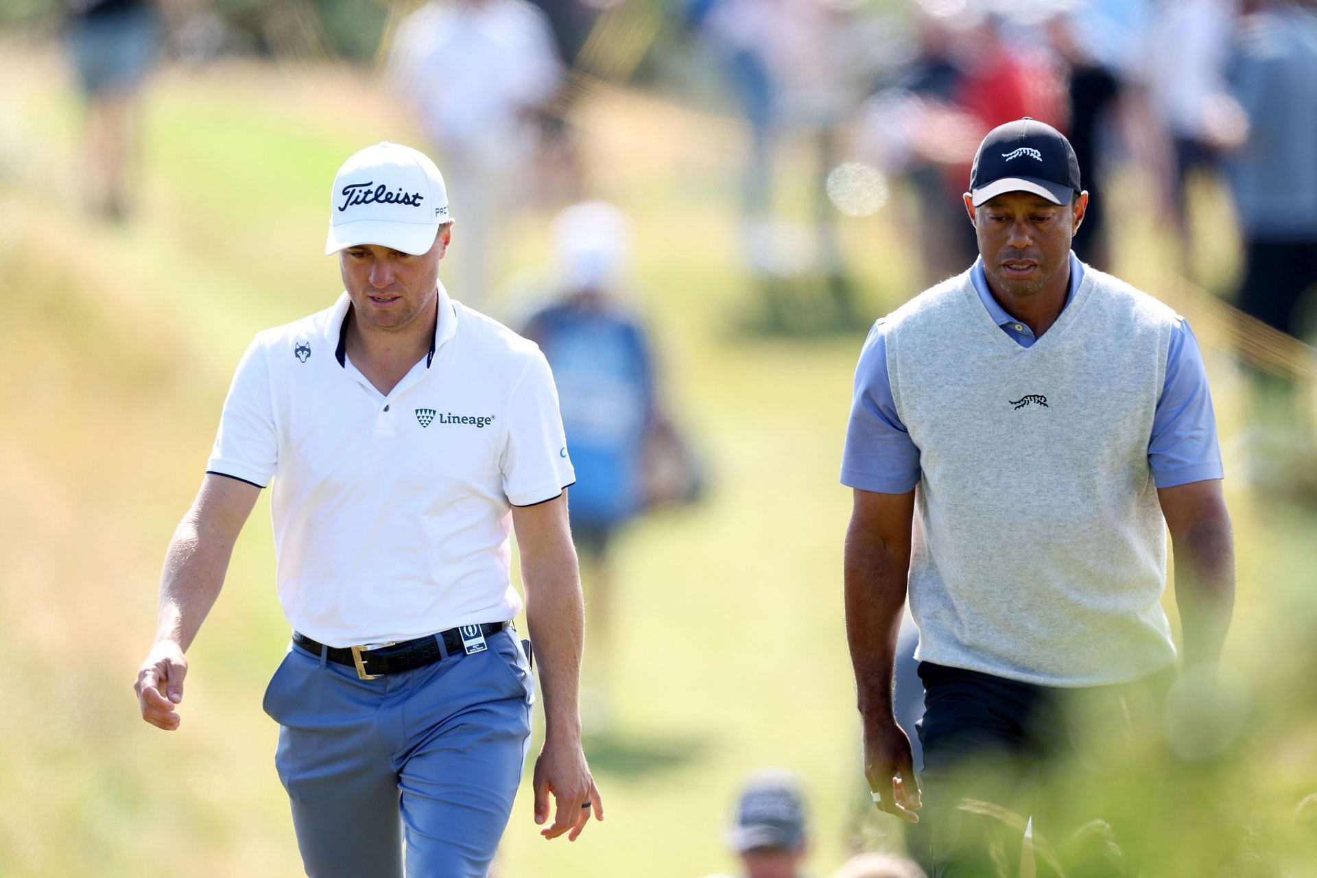 Tiger Woods and Justin Thomas walk down the fairway during the practice session before The Open Championship at Royal Troon (Image via Getty)