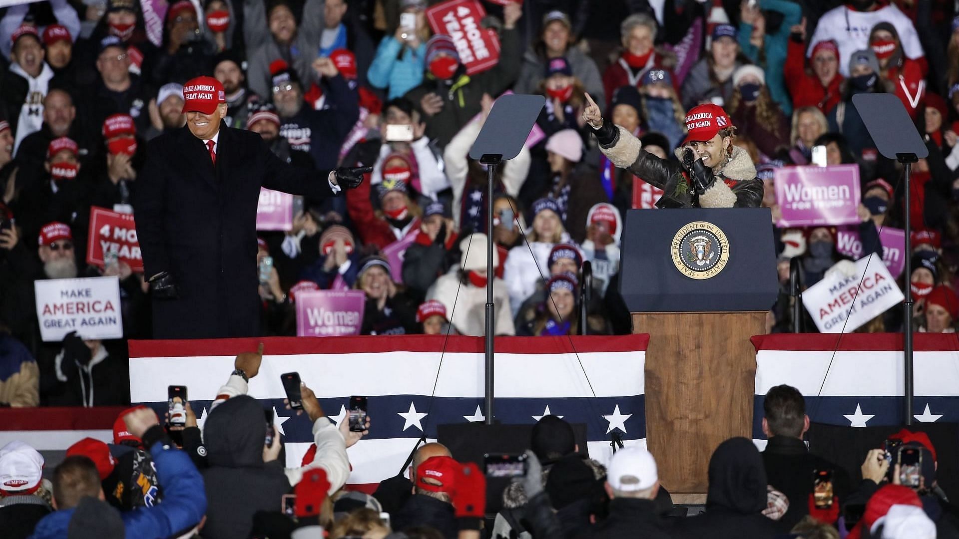 Rapper Lil Pump (R) speaks next to President Donald Trump during a rally on November 3, 2020 in Grand Rapids, Michigan. Trump and Democratic presidential nominee Joe Biden are making last-minute stops in swing states ahead of tomorrow