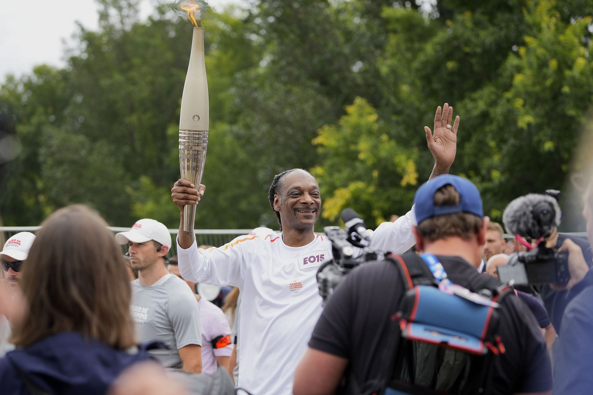 Dogg is seen carrying the Olympic flame during the torch relay ahead of the Summer Olympic Games Paris 2024. (Photo by Remon Haazen/Getty Images)