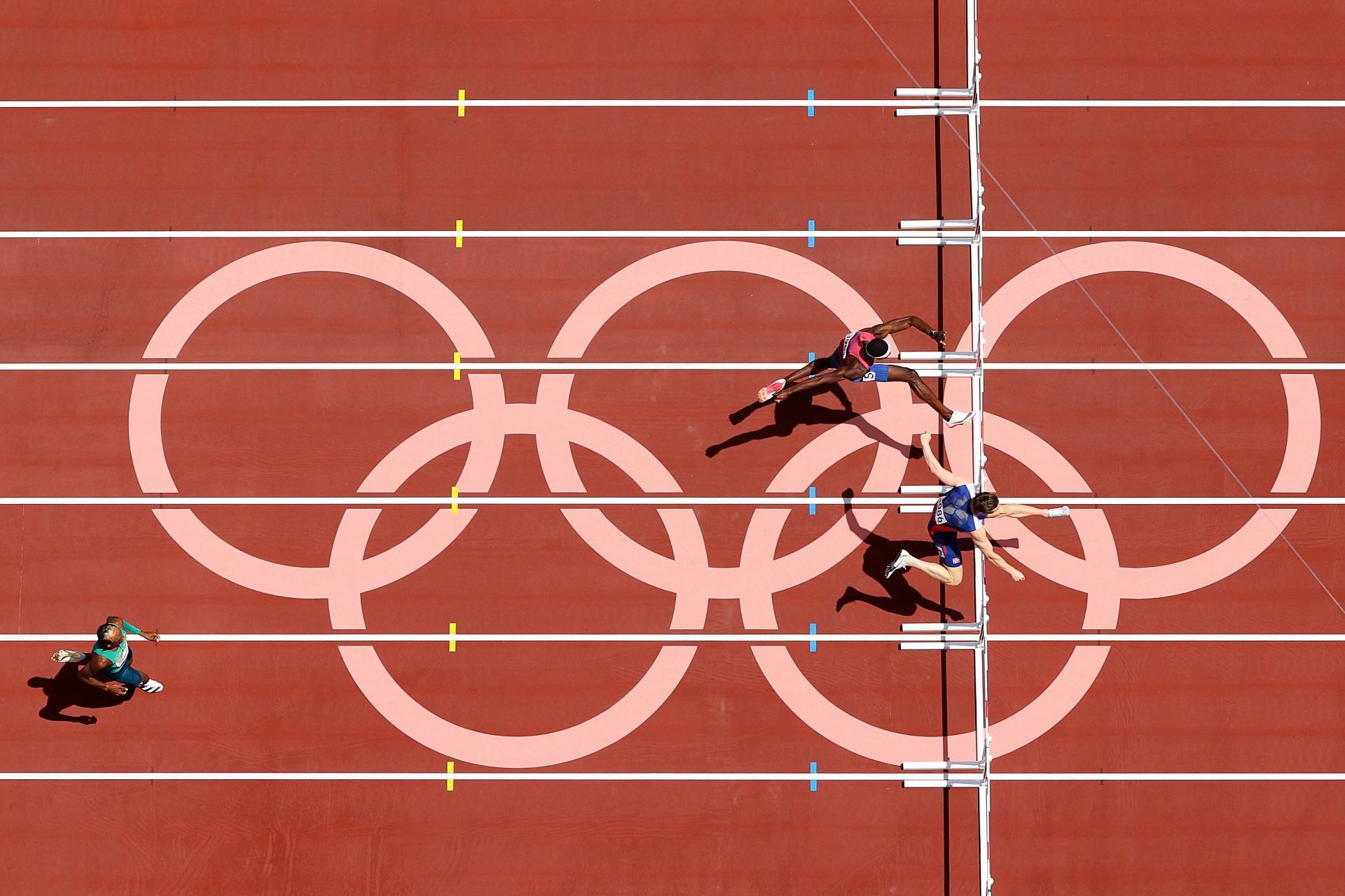 Karsten Warholm runs ahead of Rai Benjamin and Alison dos Santos in the Men&#039;s 400m Hurdles Final at the Tokyo 2020 Olympic Games. (Photo by Richard Heathcote/Getty Images)