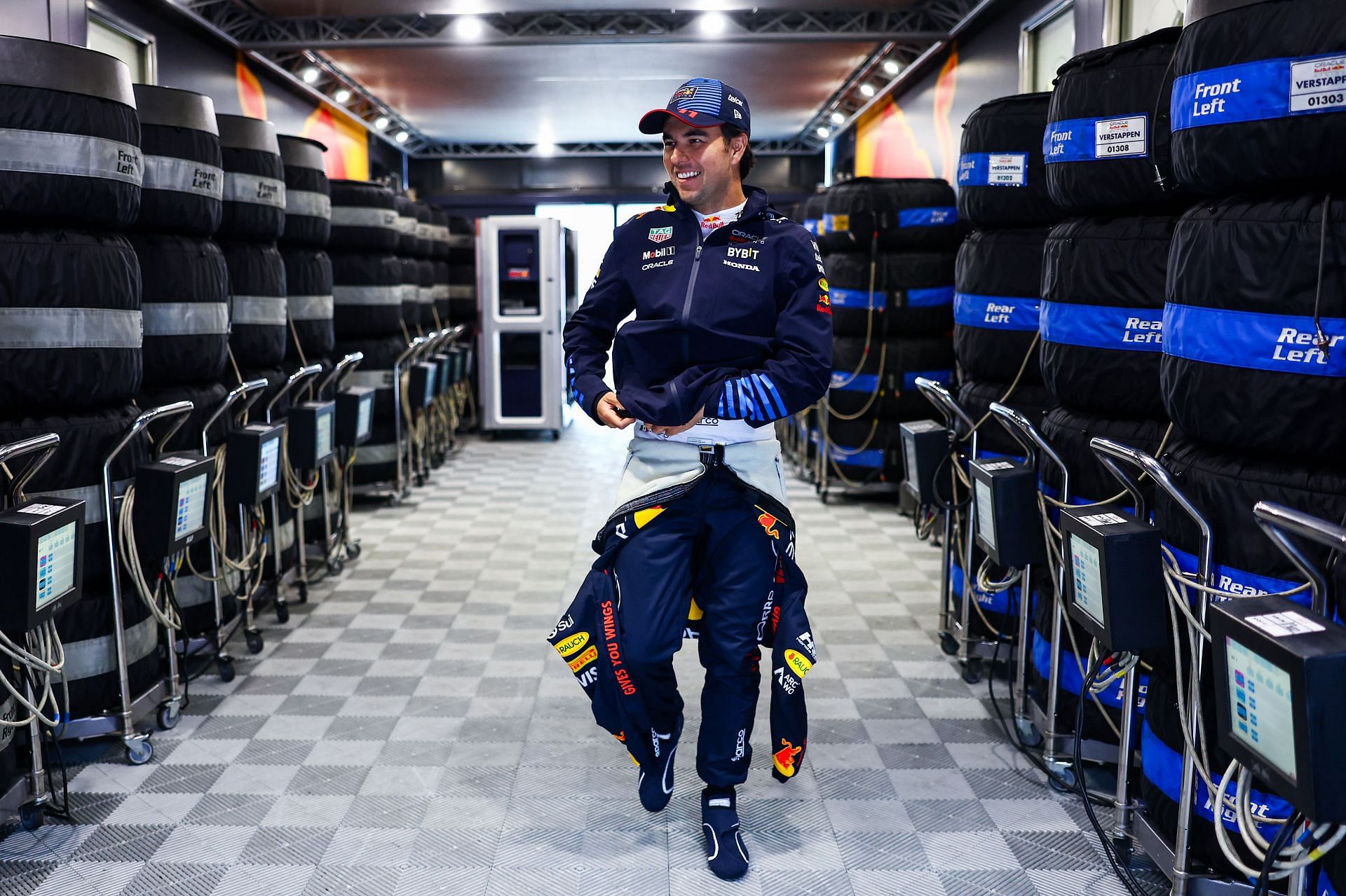 NORTHAMPTON, ENGLAND - JULY 06: Sergio Perez of Mexico and Oracle Red Bull Racing walks into the garage prior to final practice ahead of the F1 Grand Prix of Great Britain at Silverstone Circuit on July 06, 2024 in Northampton, England. (Photo by Mark Thompson/Getty Images)