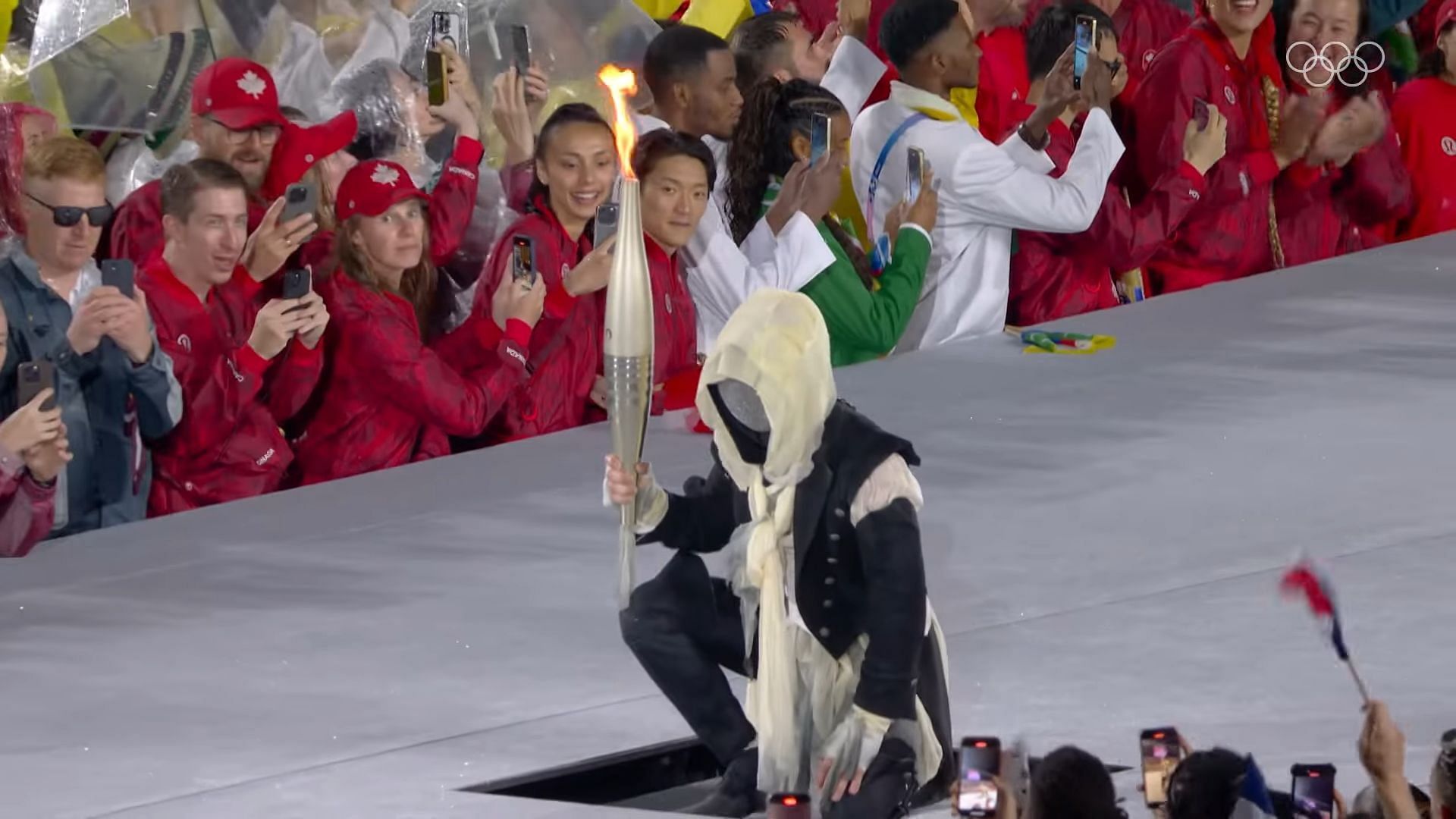 The identity of the masked torchbearer at the Olympics left people around the world intrigued (Image via YouTube/Olympics)