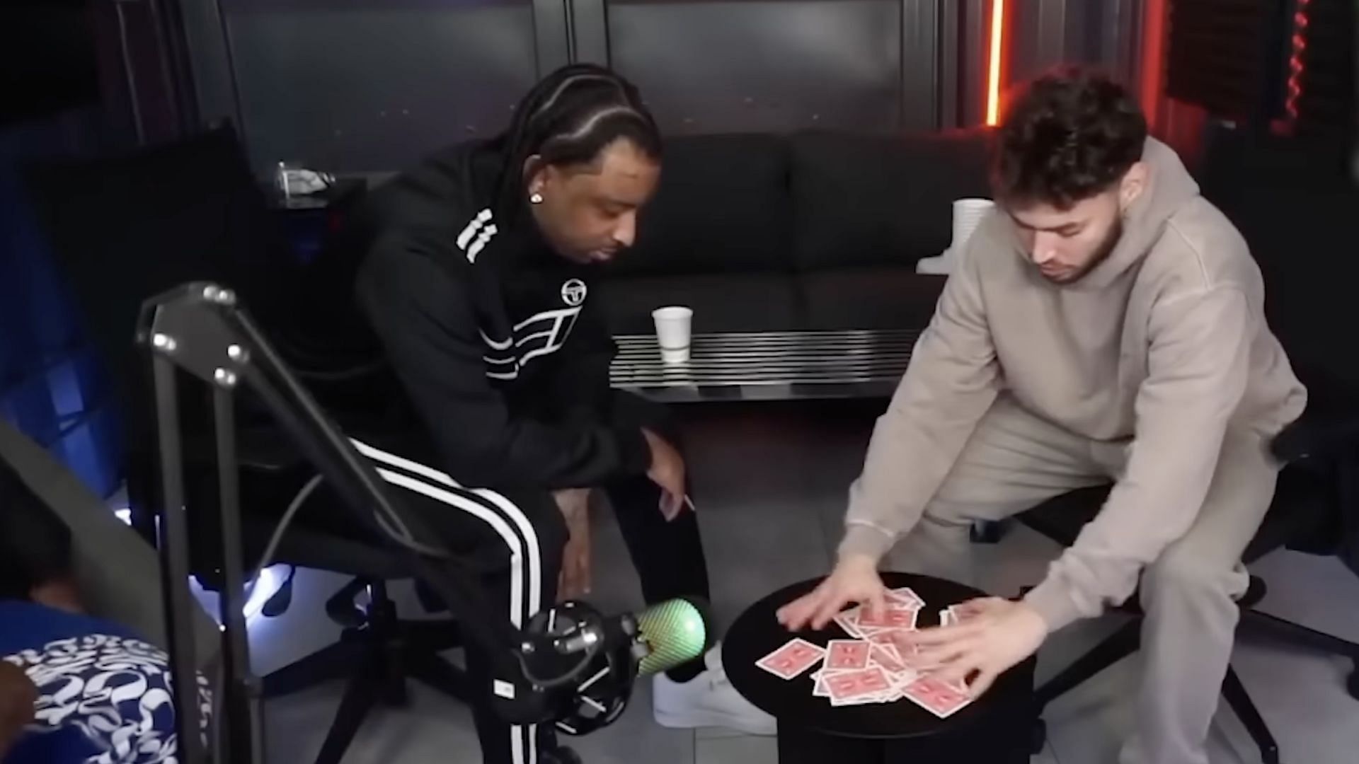 Adin Ross playing cards with 21 Savage on his livestream on February 02, 2024 (Image via YouTube/@AdinRoss)