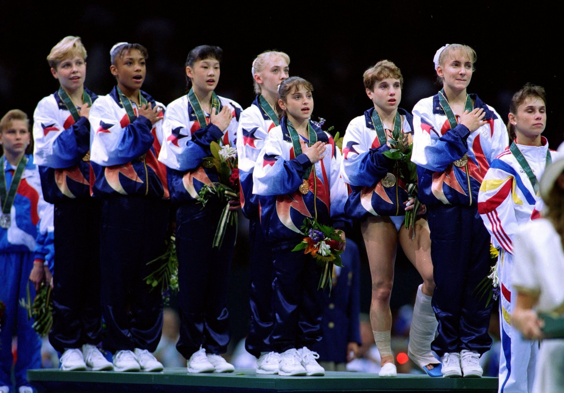 Kerri Strug [3rd from Right] singing the national anthem at the Atlanta Olympics [Image Source: Getty]