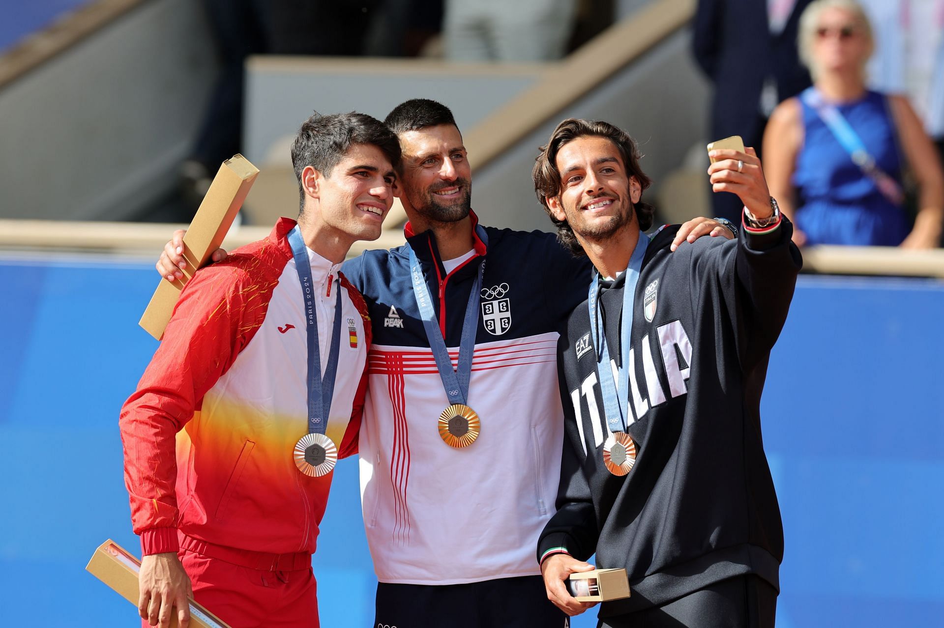 Carlos Alcaraz, Novak Djokovic &amp; Lorenzo Musetti with their Olympic silver, gold, and bronze medals, respectively | Getty