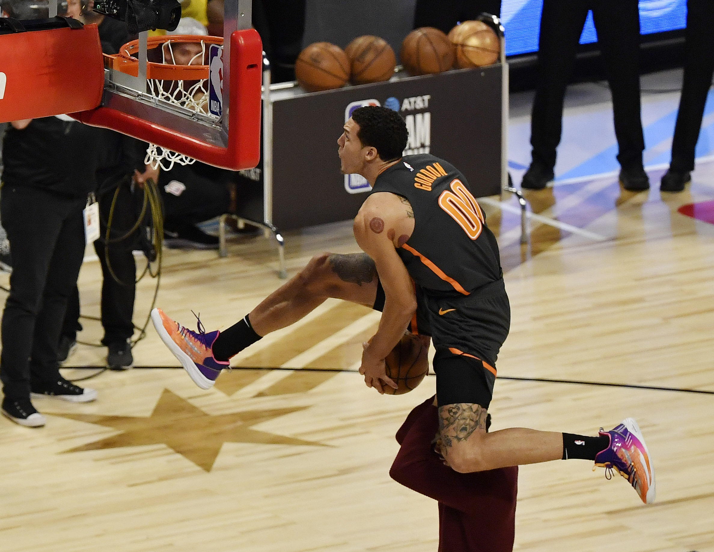 Orlando Magic player Aaron Gordon dunks over Chance the Rapper in the slam dunk contest during NBA All-Star Saturday Night at United Center (Credits: IMAGN)