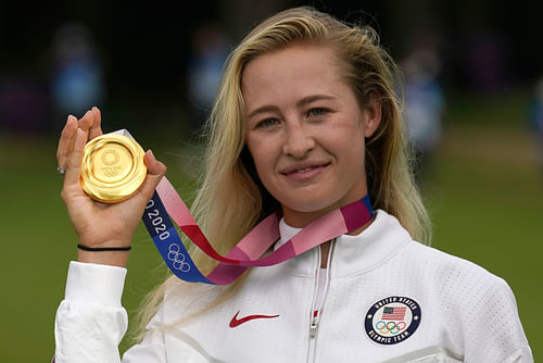 Nelly Korda posing with the gold medal she won at the Tokyo Olympics [Image via Imagn]