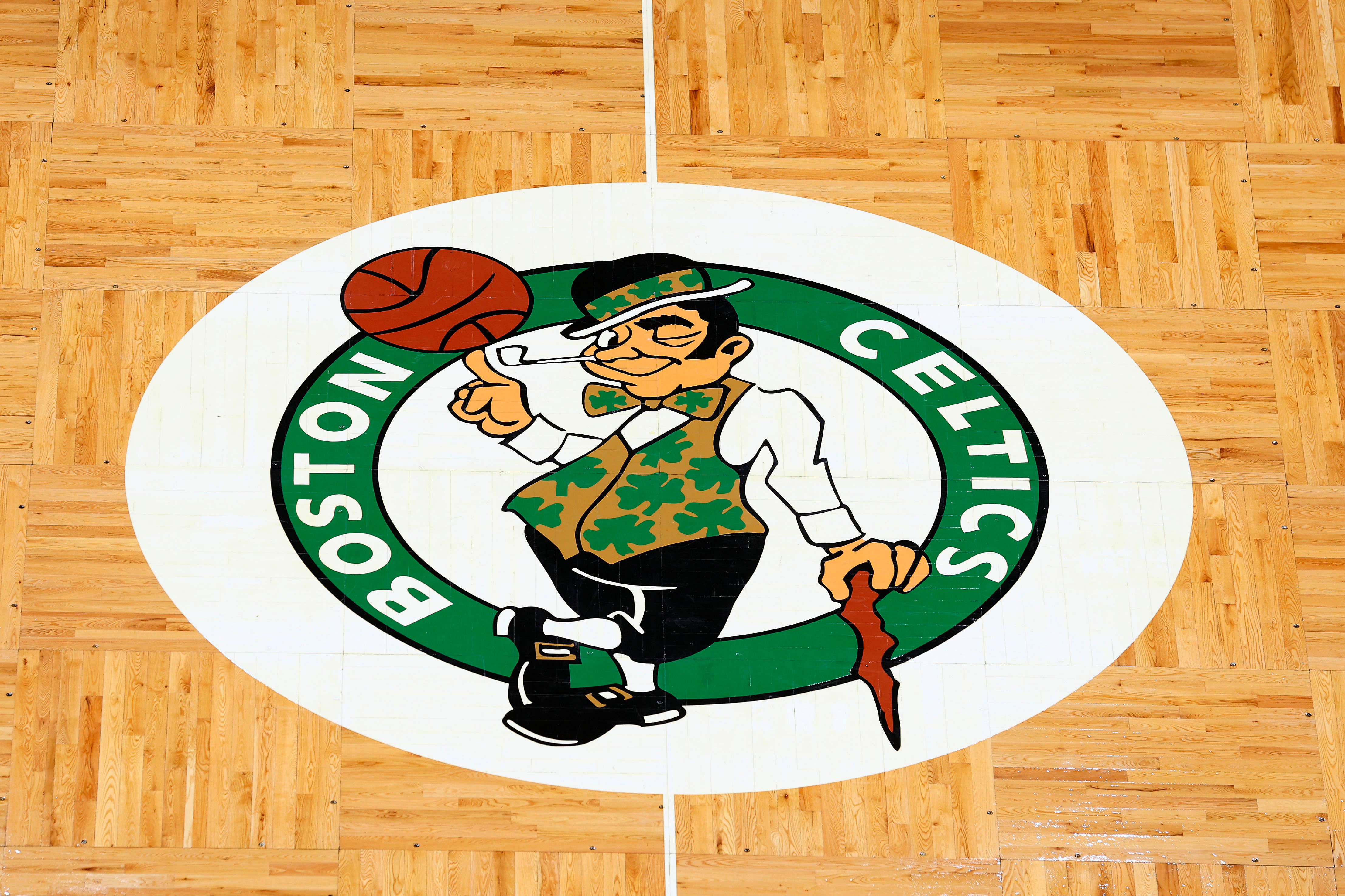 The Boston Celtics logo is seen on the parquet floor at center court at TD Garden. Photo Credit: Imagn