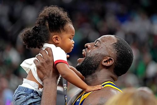 Draymond Green lifts his daughter Kyla Green after the Golden State Warriors beat the Boston Celtics in the 2022 NBA Finals. Photo Credit: Imagn