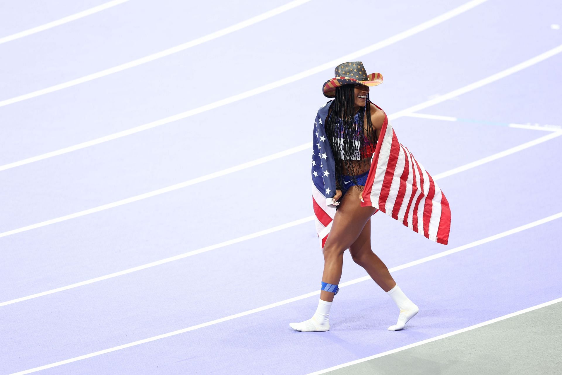 Tara Davis-Woodhall celebrates her gold medal win at the Paris Olympics