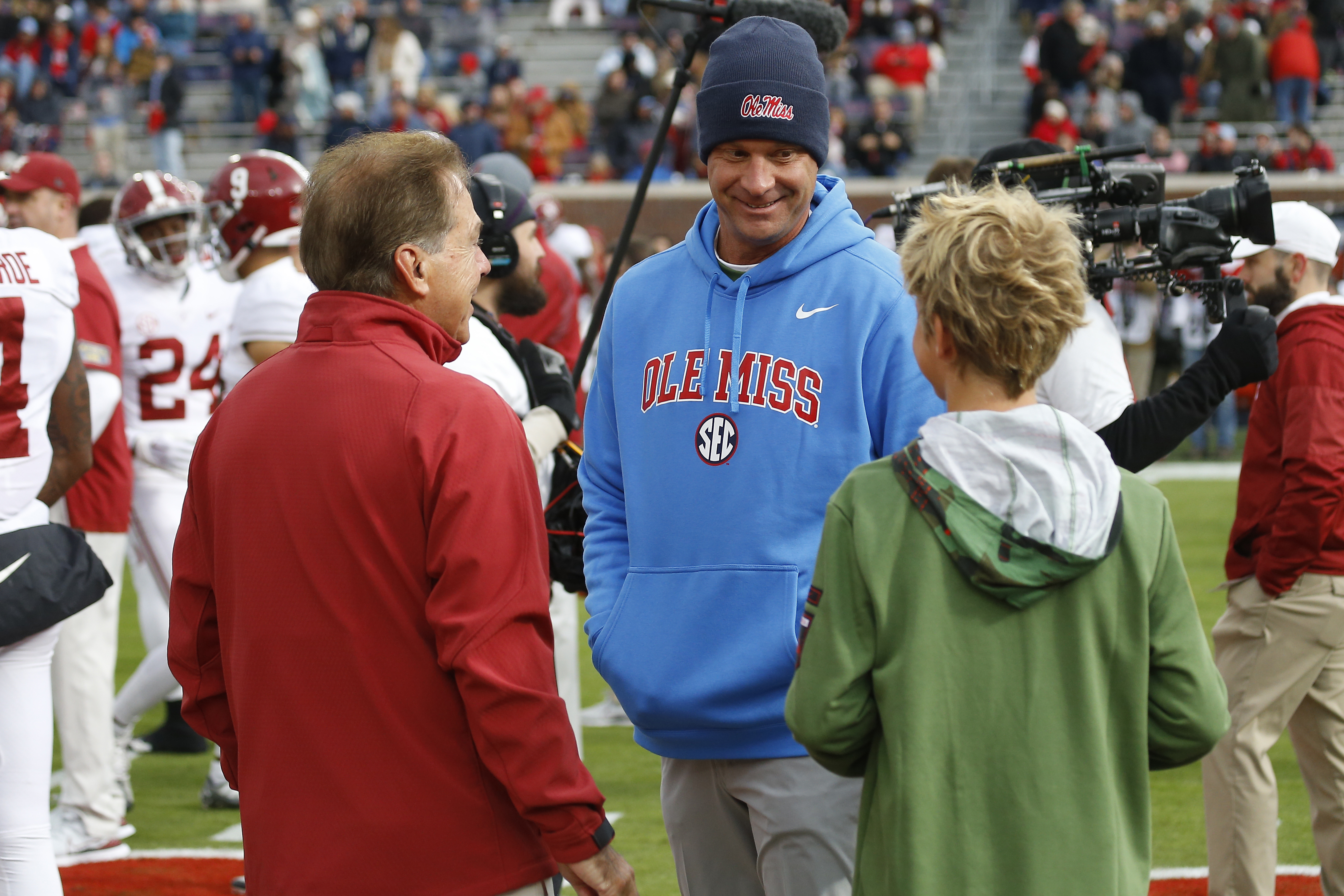 Former Alabama Crimson Tide head coach Nick Saban (left) and Mississippi Rebels head coach Lane Kiffin (middle) and Knox Kiffin - Source: Imagn