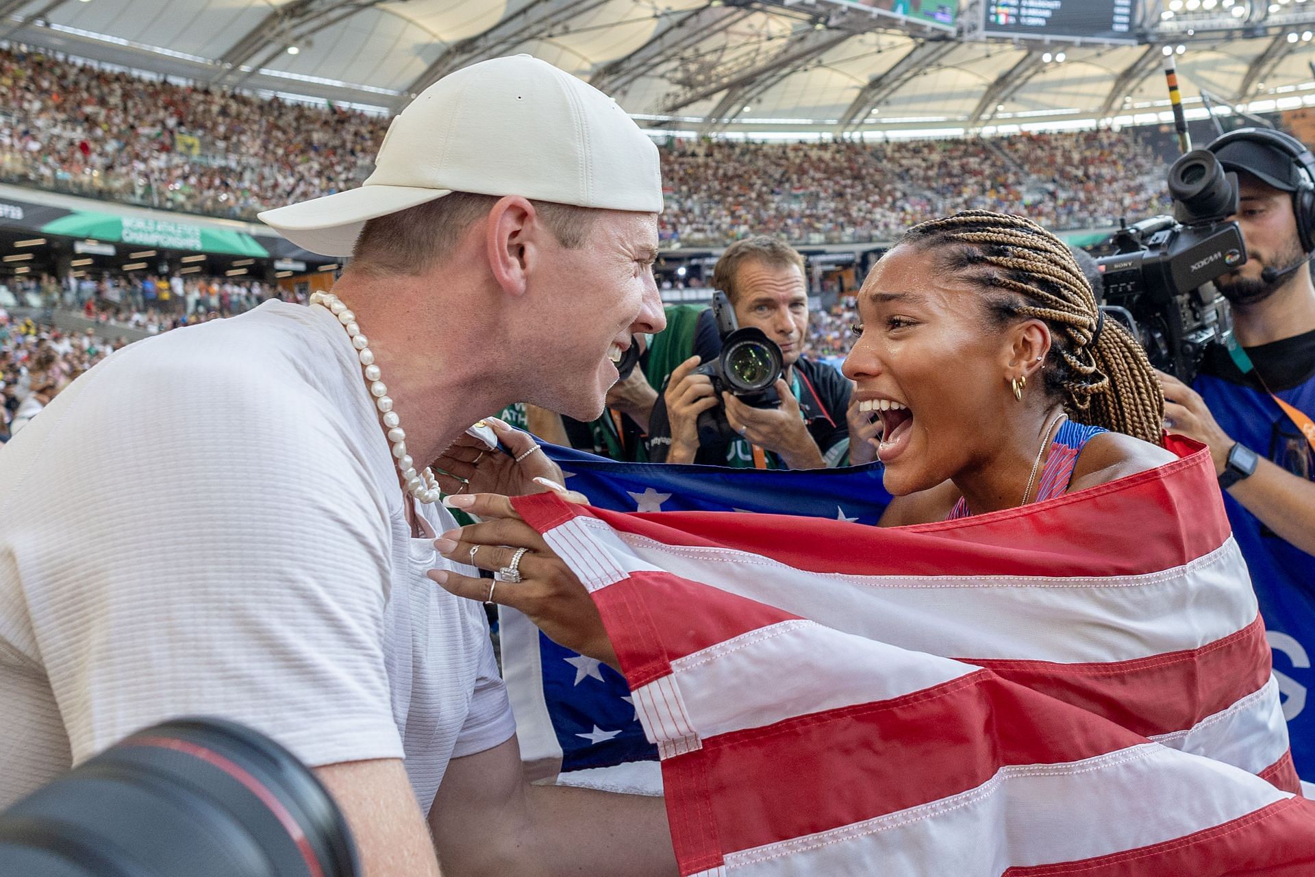 Tara Davis-Woodhall with husband Hunter Woodhall after winning maiden Olympic gold - Source: Getty