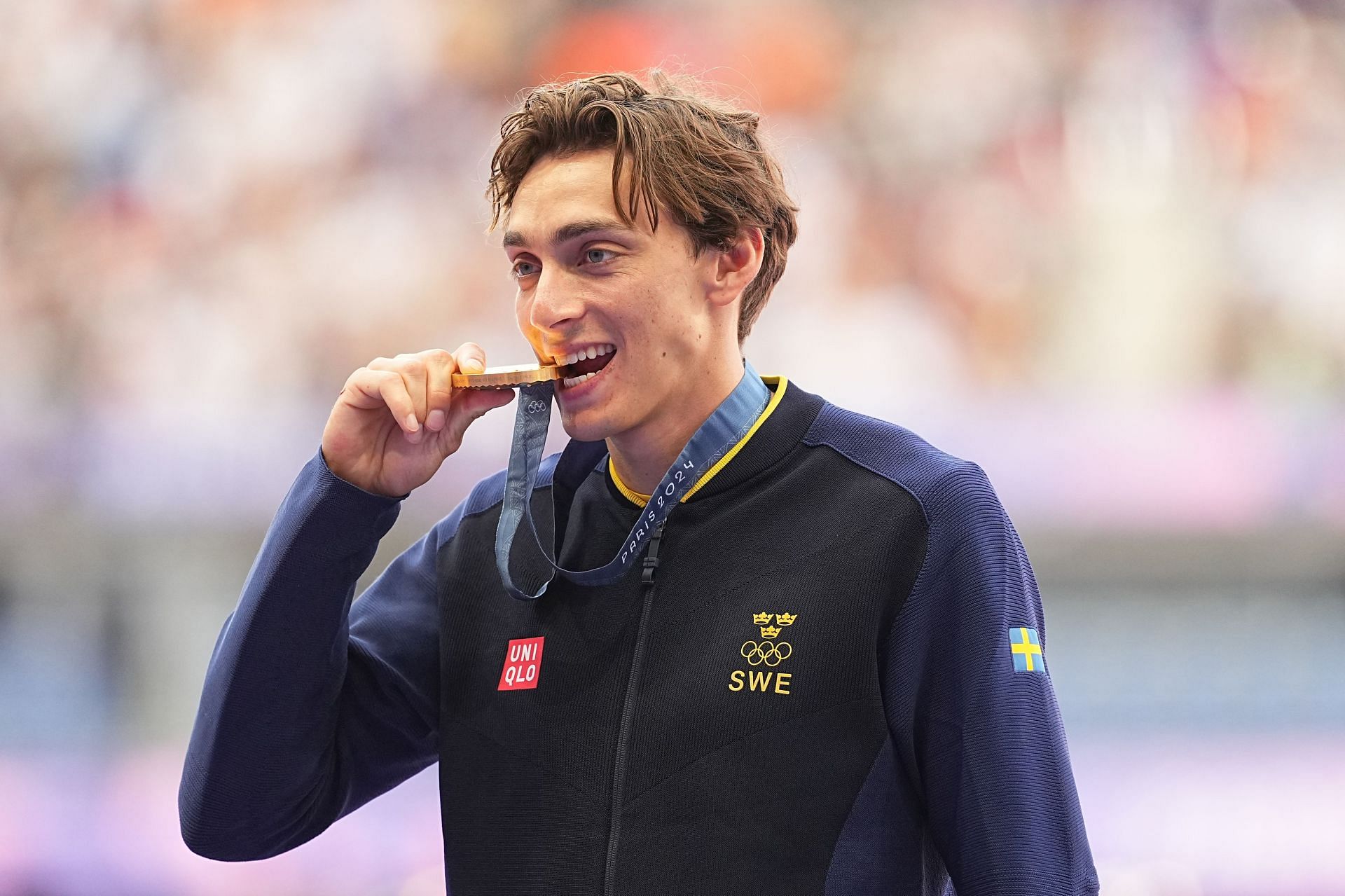 Armand Mondo Duplantis of Sweden bites his gold medal from men&#039;s pole vault at the Paris Olympics 2024 [Image Source: Getty]