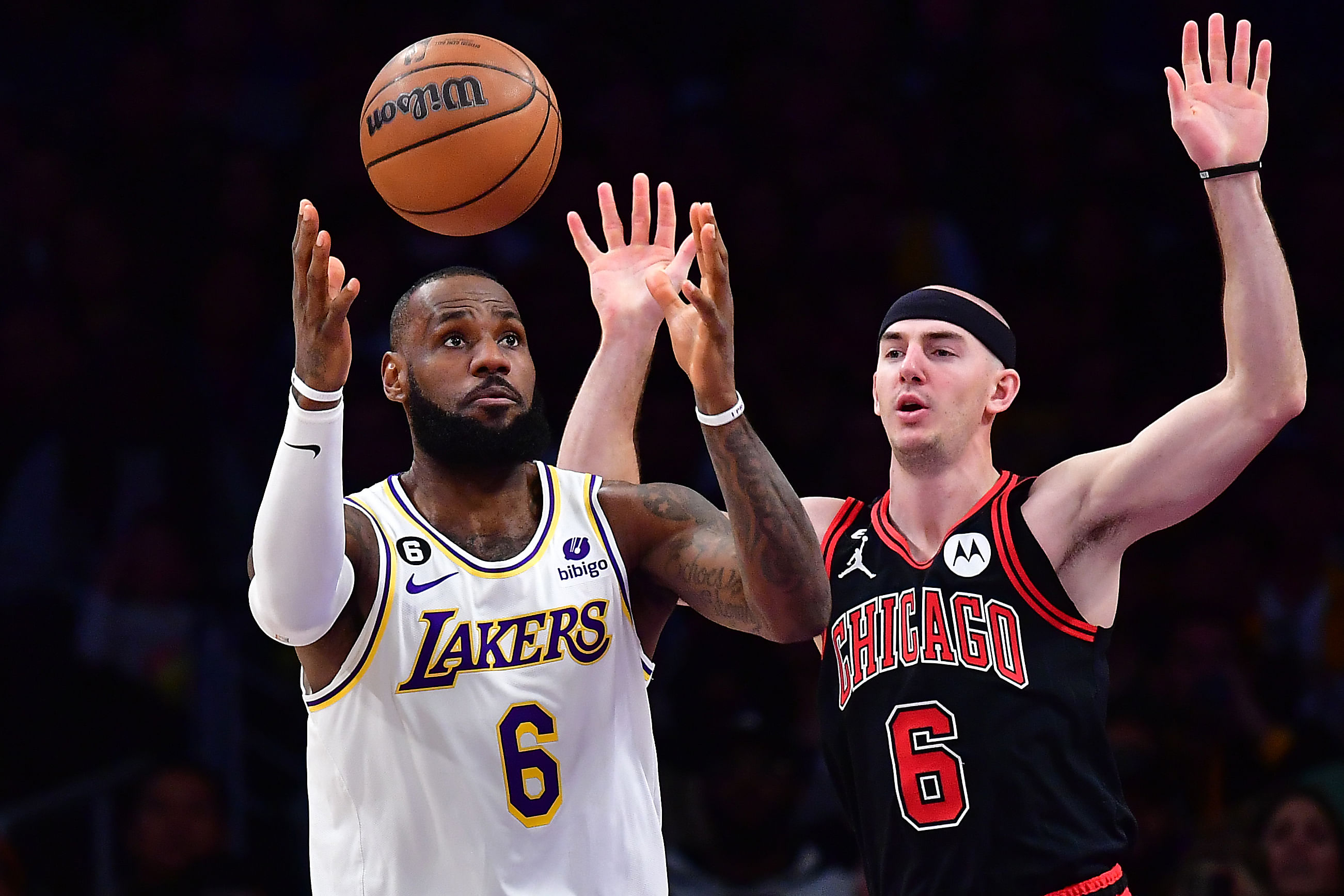 Los Angeles Lakers forward LeBron James plays for the ball against Alex Caruso during the first half at Crypto.com Arena. Photo Credit: Imagn