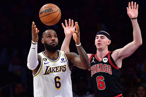 Los Angeles Lakers forward LeBron James plays for the ball against Alex Caruso during the first half at Crypto.com Arena. Photo Credit: Imagn