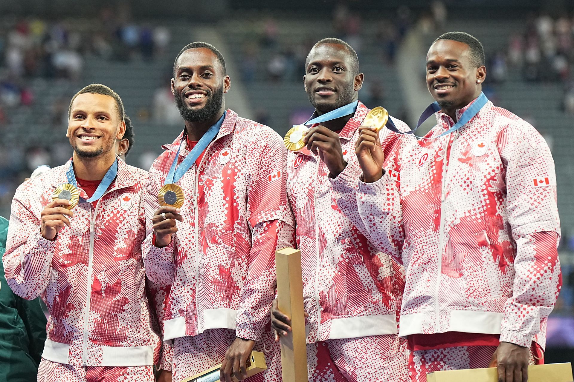 Aaron Brown, Jerome Blake, Brendon Rodney and Andre De Grasse celebrates on the podium. (Photo via Getty Images)