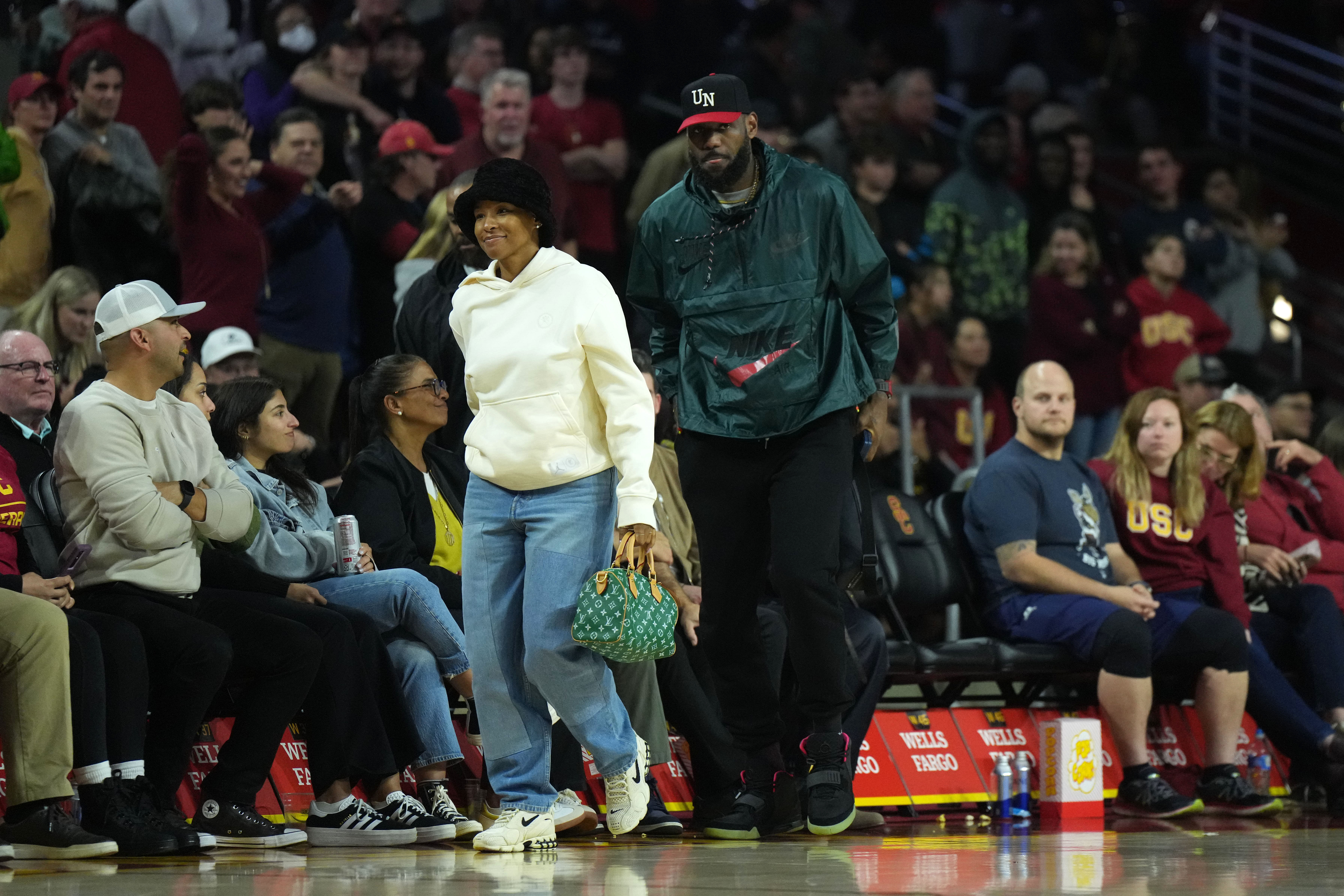 Los Angeles Lakers forward LeBron James and wife, Savannah James, attend the game between the Southern California Trojans and the Washington State Cougars at the Galen Center. Photo Credit: Imagn