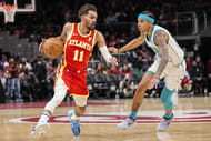 Atlanta Hawks guard Trae Young dribbles past Charlotte Hornets guard Tre Mann at State Farm Arena. Photo Credit: Imagn