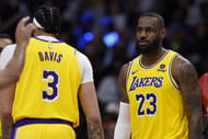 Los Angeles Lakers forward LeBron James talks with forward Anthony Davis during a game against the Washington Wizards. Photo Credit: Imagn