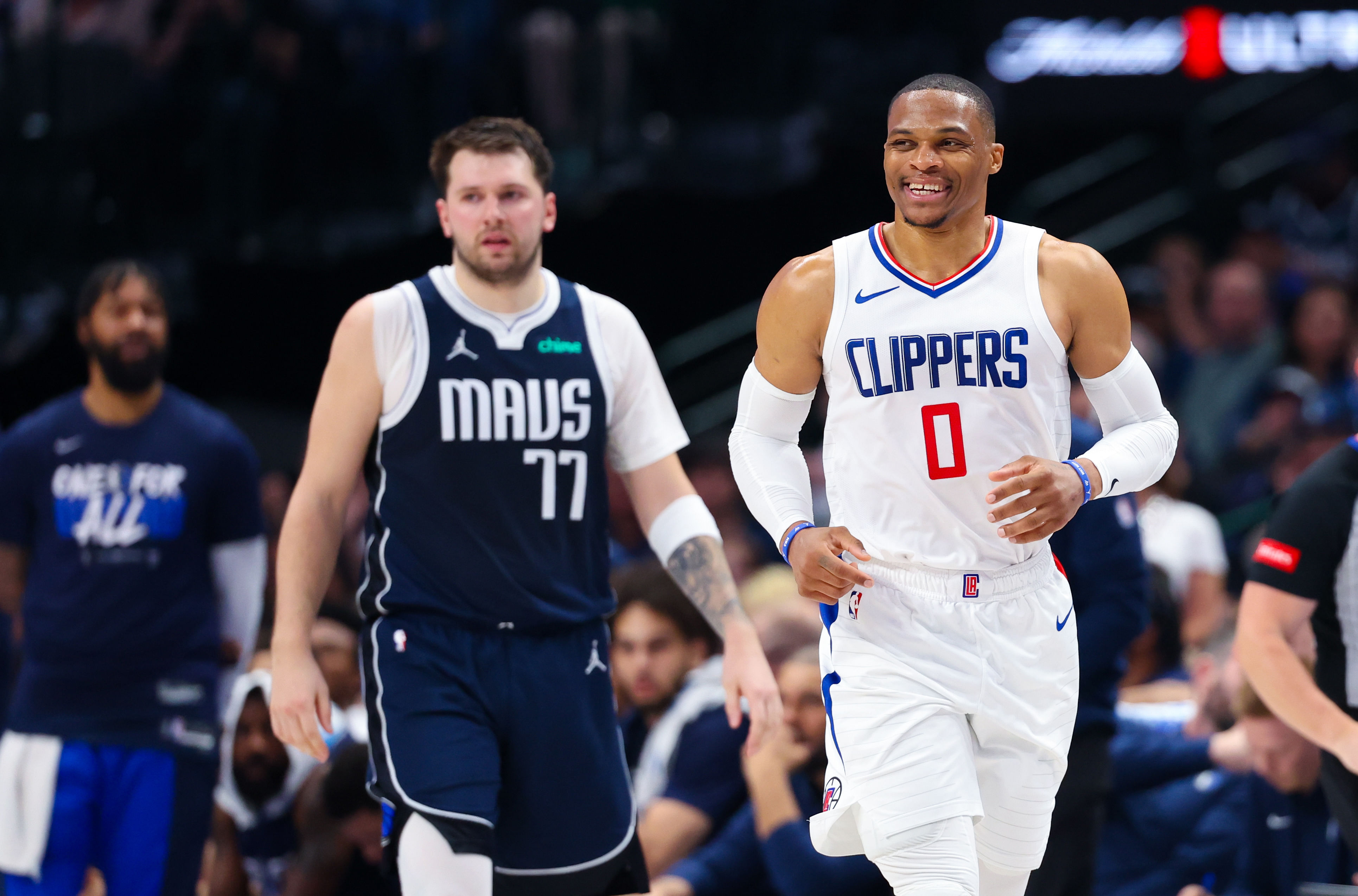 Russell Westbrook laughs in front of Luka Doncic (77) during the 2024 NBA playoffs at American Airlines Center. Photo Credit: Imagn