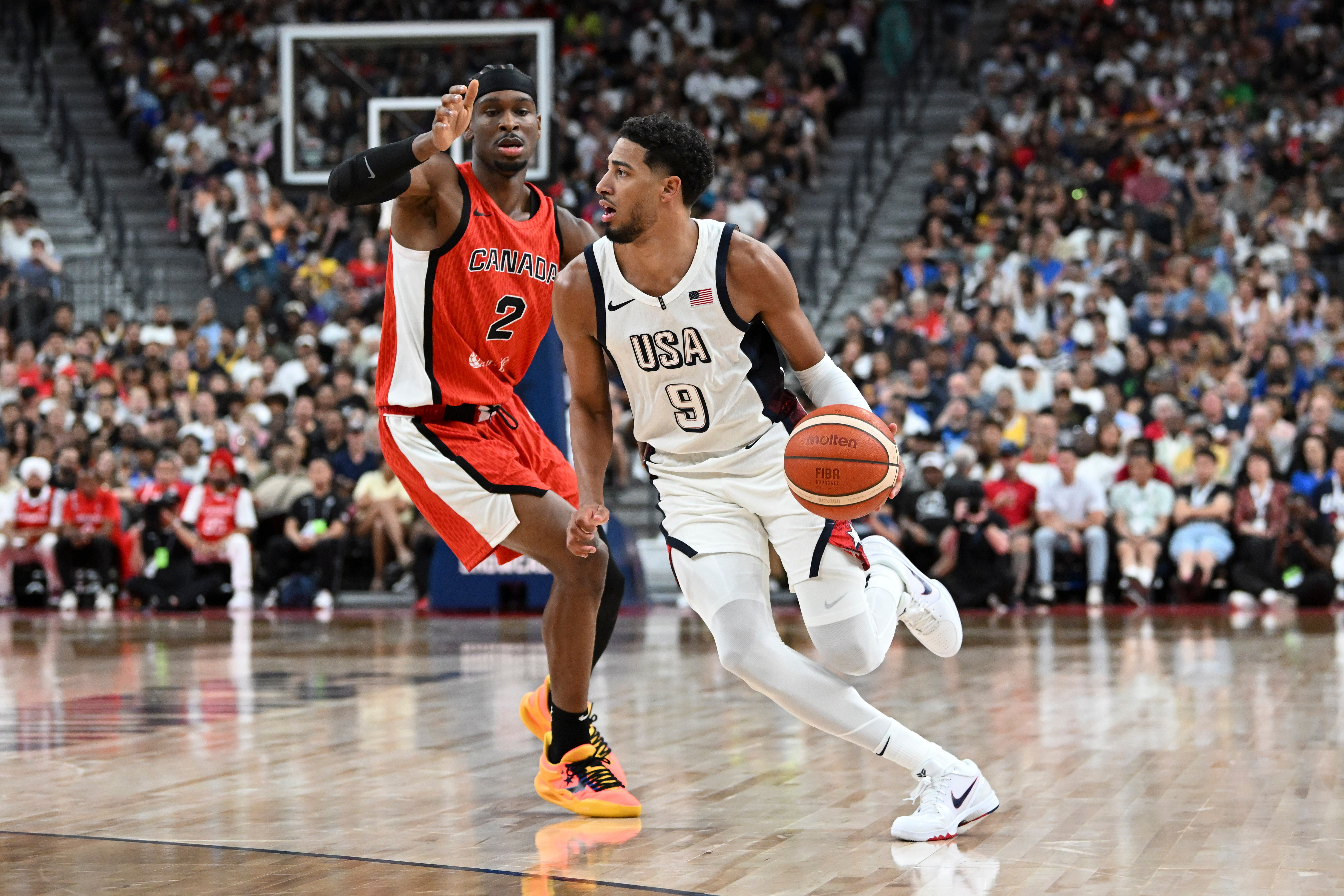 USA guard Tyrese Haliburton dribbles past Canada guard Shai Gilgeous-Alexander at T-Mobile Arena. Photo Credit Imagn