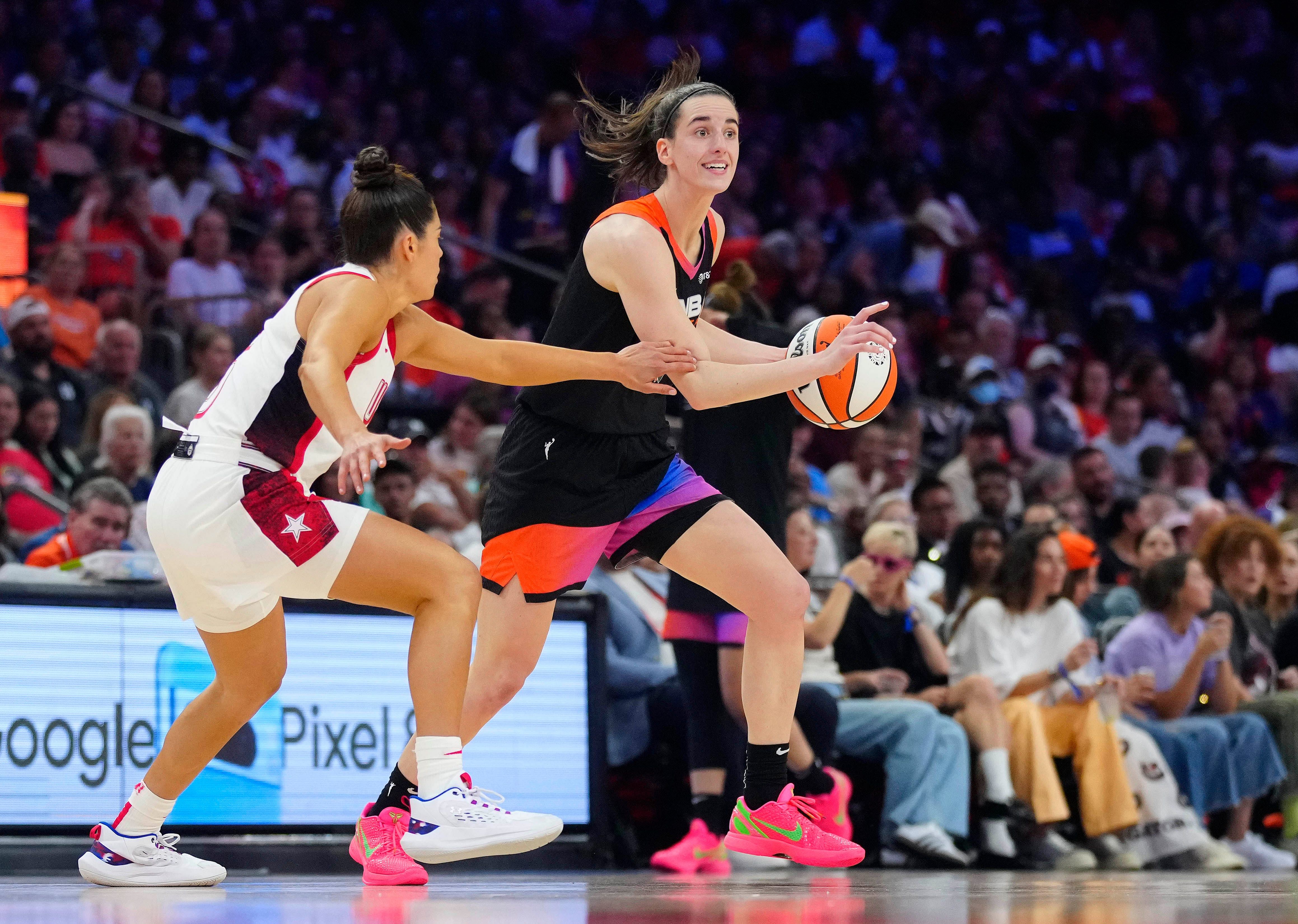 Team WNBA guard Caitlin Clark drives against Team USA guard Kelsey Plum during the WNBA All-Star Game. Credit: Imagn