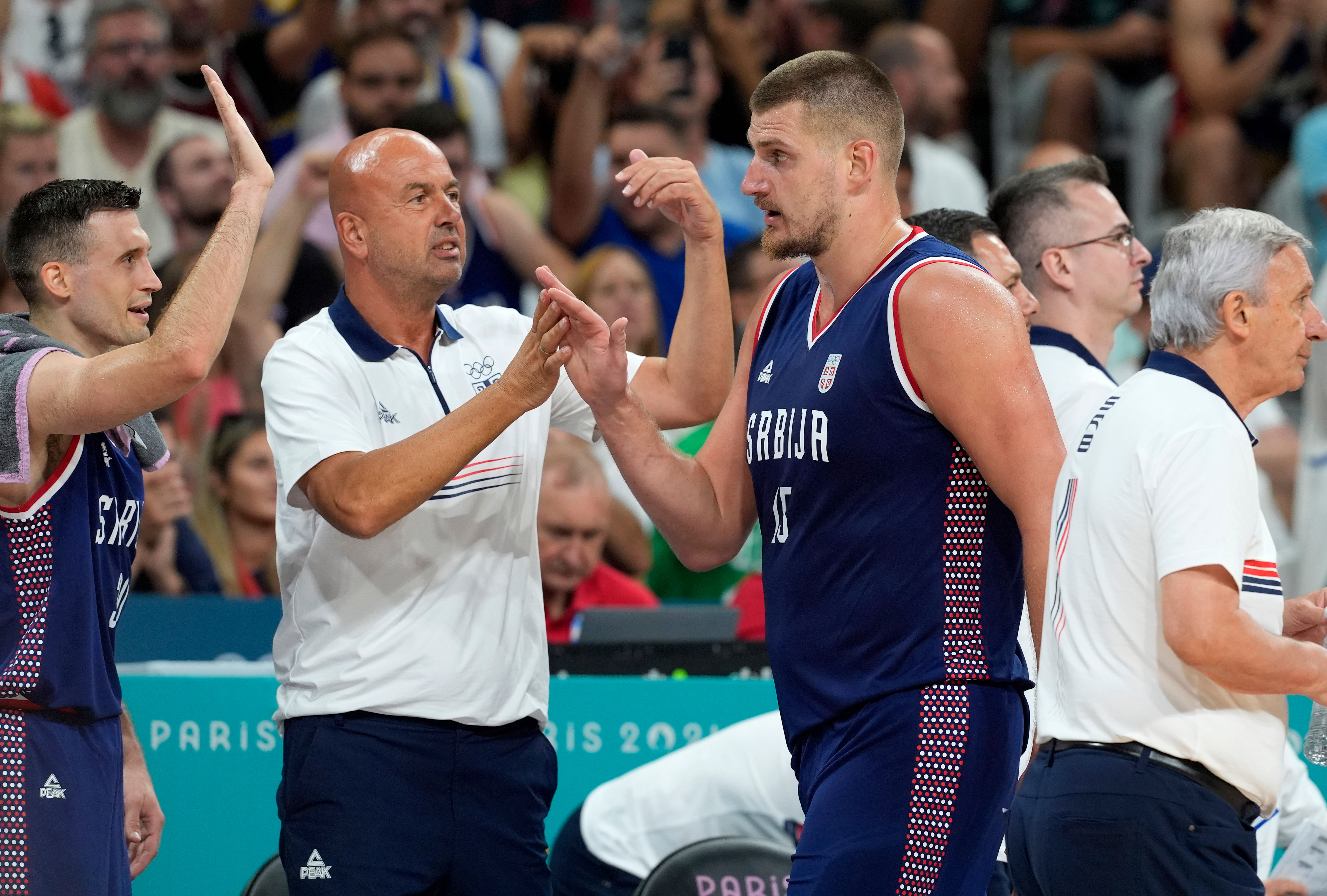 Serbia&#039;s Nikola Jokic celebrates with coaches and teammates after a play against Puerto Rico during the Paris Olympics basketball event at Stade Pierre-Mauroy (Photo Credit: Imagn)