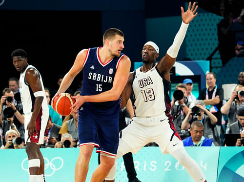 Nikola Jokic controls the ball while defended by Bam Adebayo at the Olympics men's basketball event. Photo Credit: IMAGN