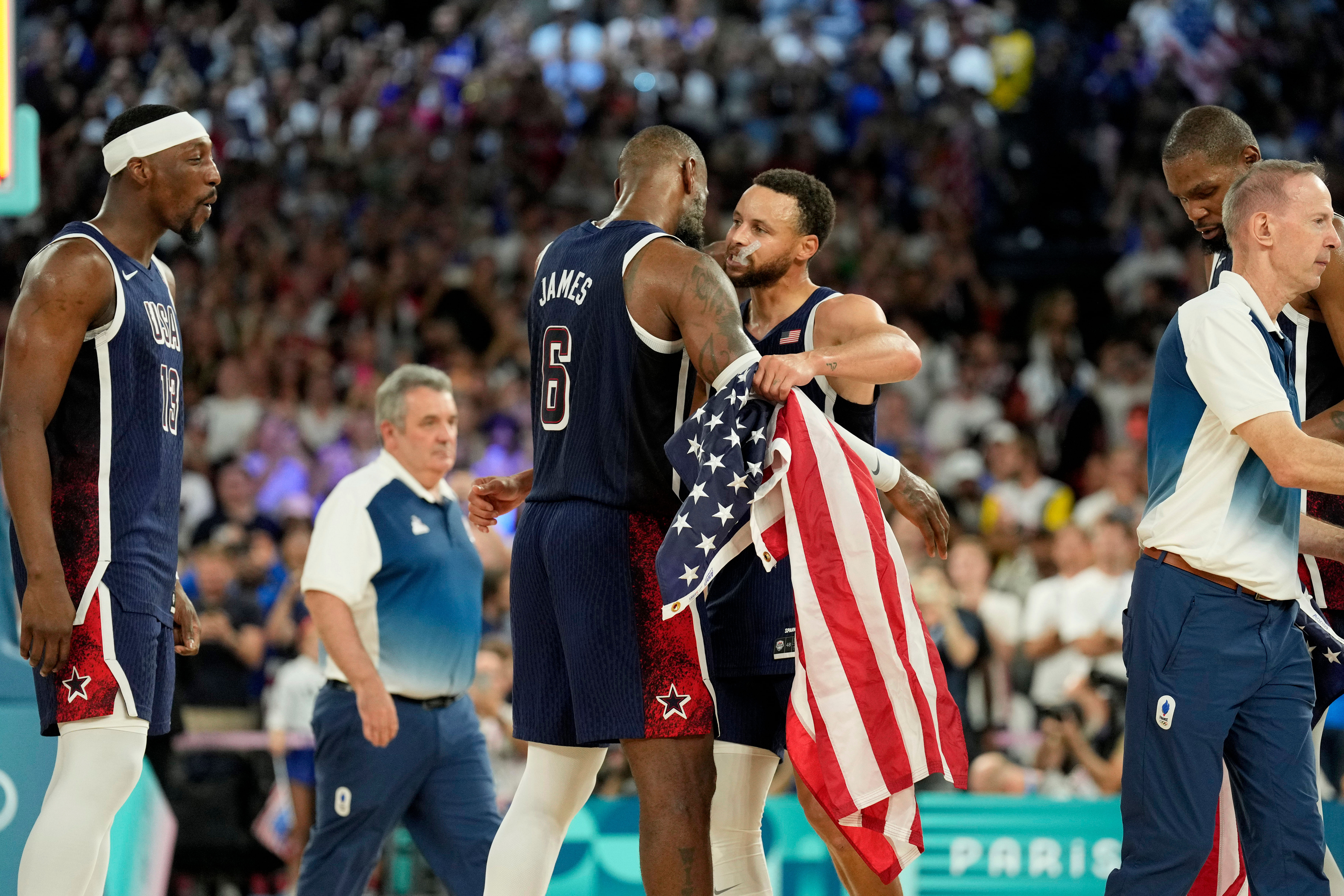 USA shooting guard Stephen Curry and guard LeBron James celebrate after defeating France in the Paris 2024 Olympic Summer Games. Photo Credit: Imagn