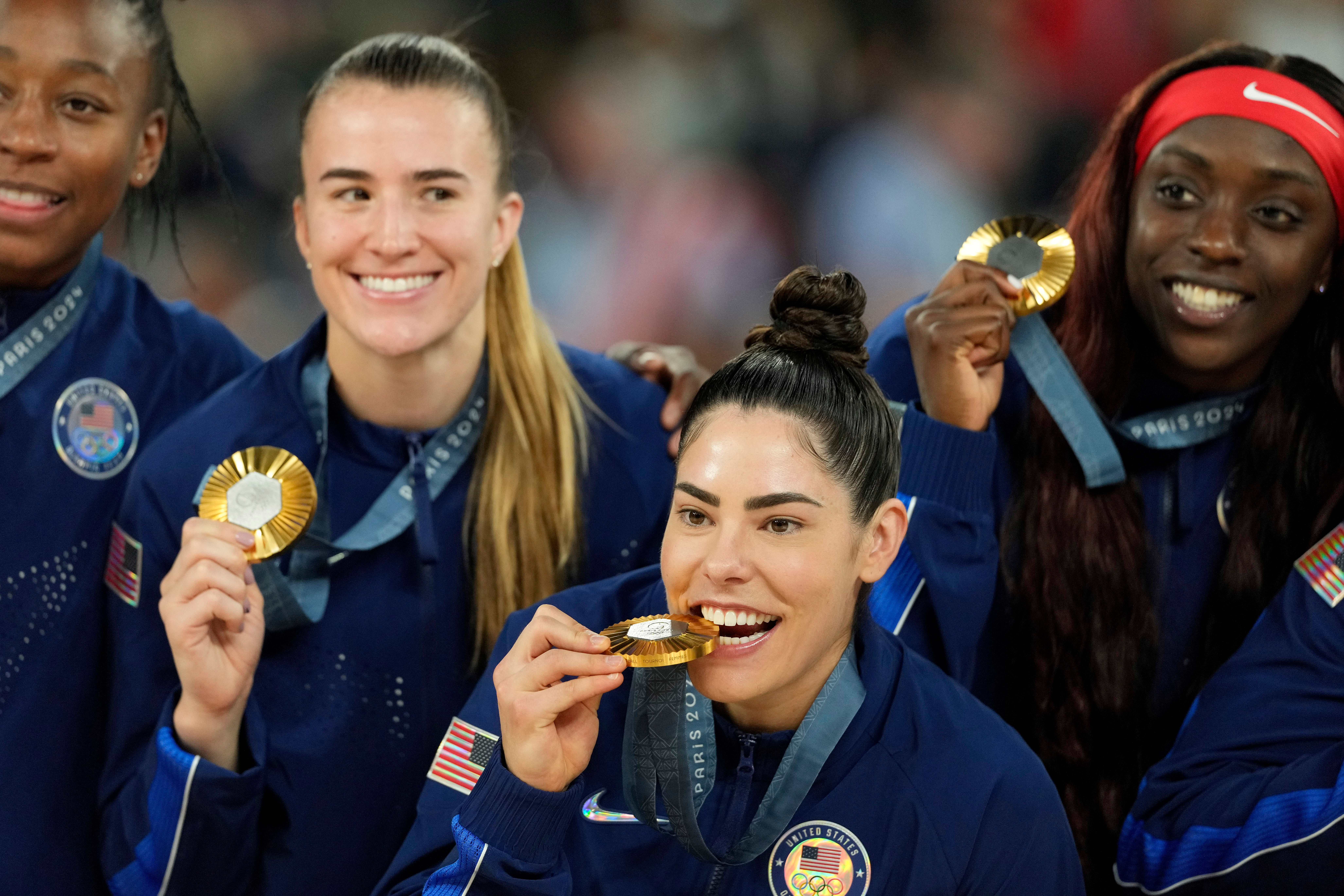 Kelsey Plum celebrates with Sabrina Ionescu and Kahleah Copper after defeating France in the women&#039;s gold medal game during the Paris 2024 Olympics. Photo Credit: Imagn