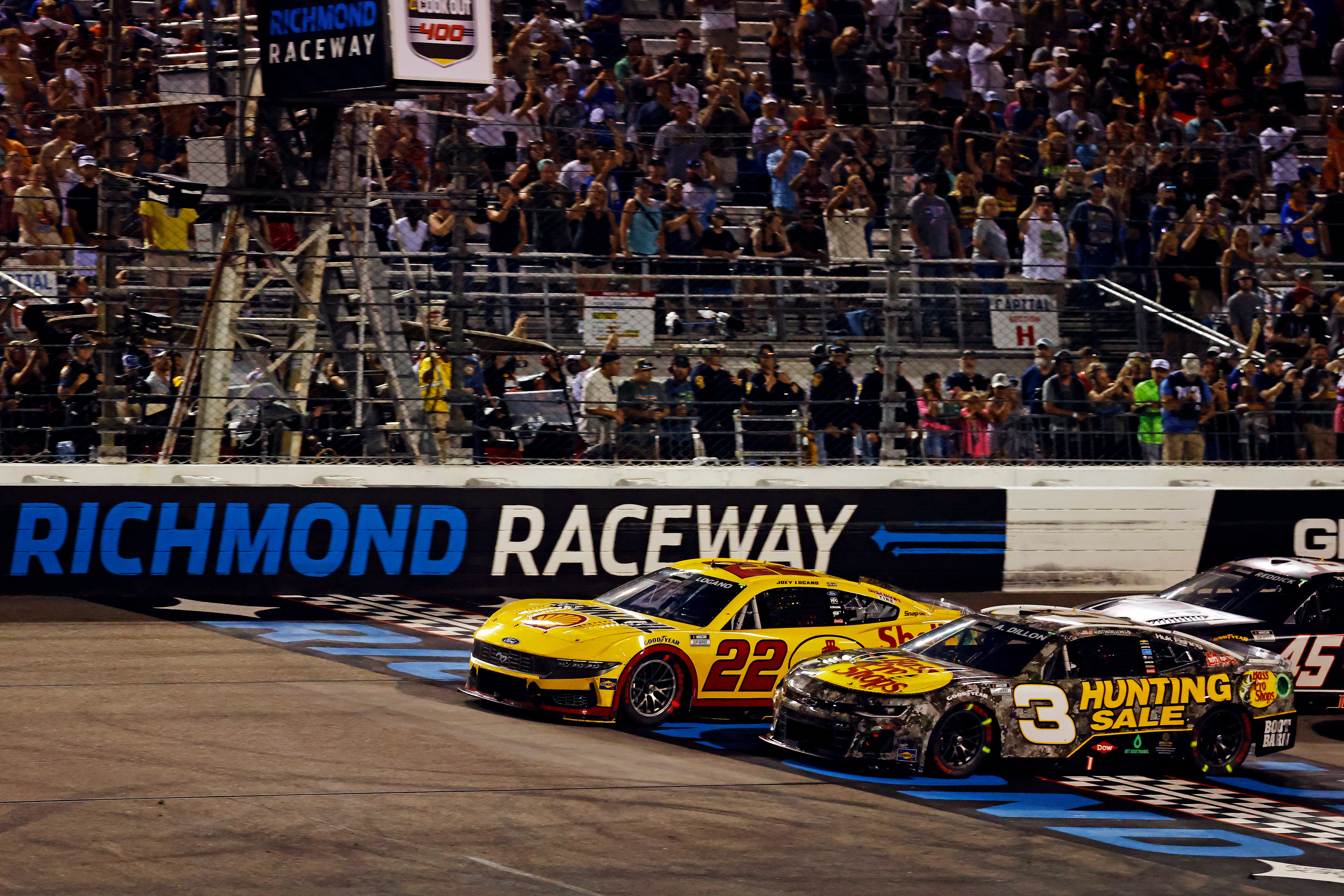 Joey Logano (22) and NASCAR Cup Series driver Austin Dillion (3) restart the race for overtime during the Cook Out 400 at Richmond Raceway. Mandatory Credit: Peter Casey-USA TODAY Sports. Source: Imagn