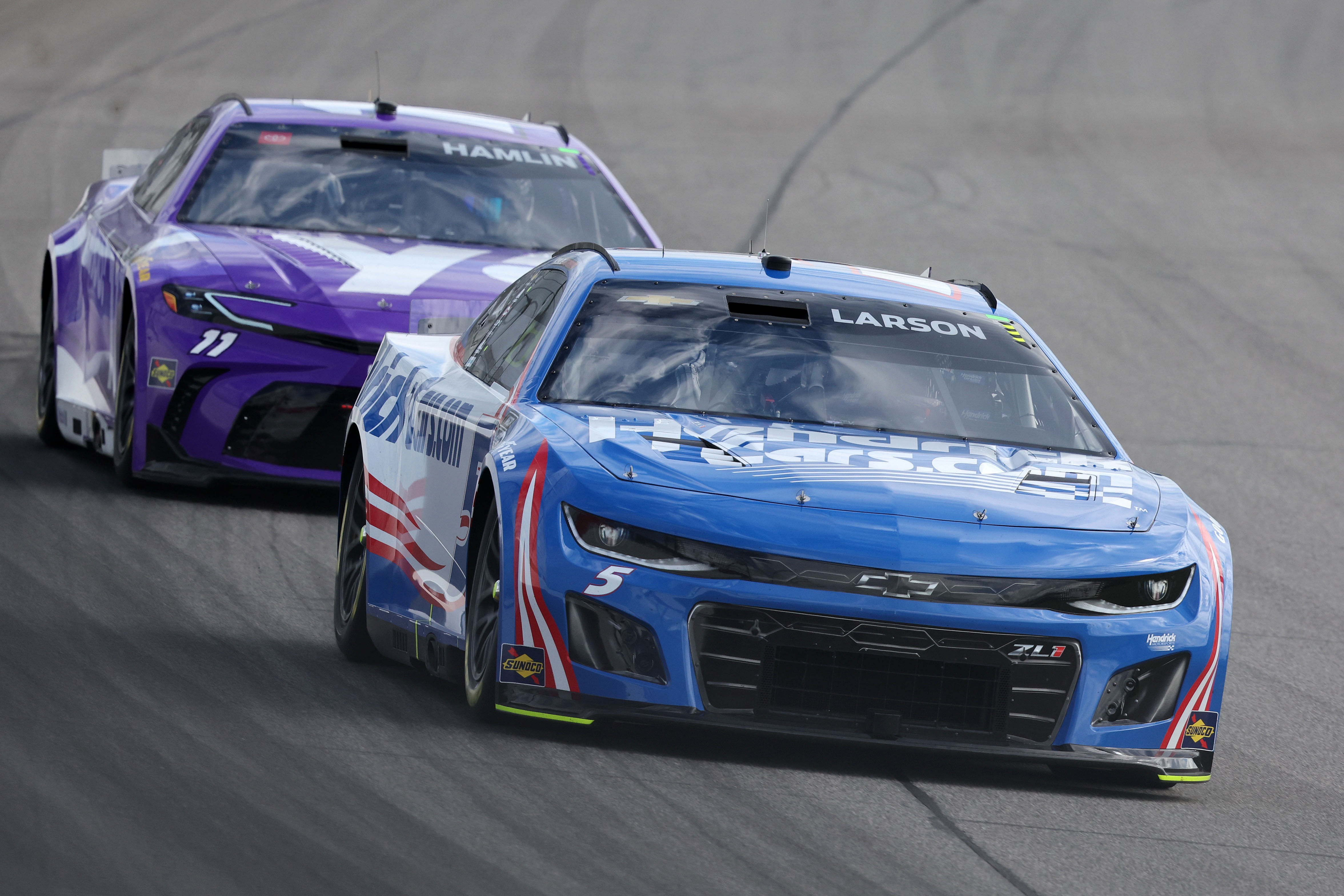 Kyle Larson (5) leads driver Denny Hamlin (11) during the FireKeepers 400 at Michigan International Speedway (Image via Imagn)