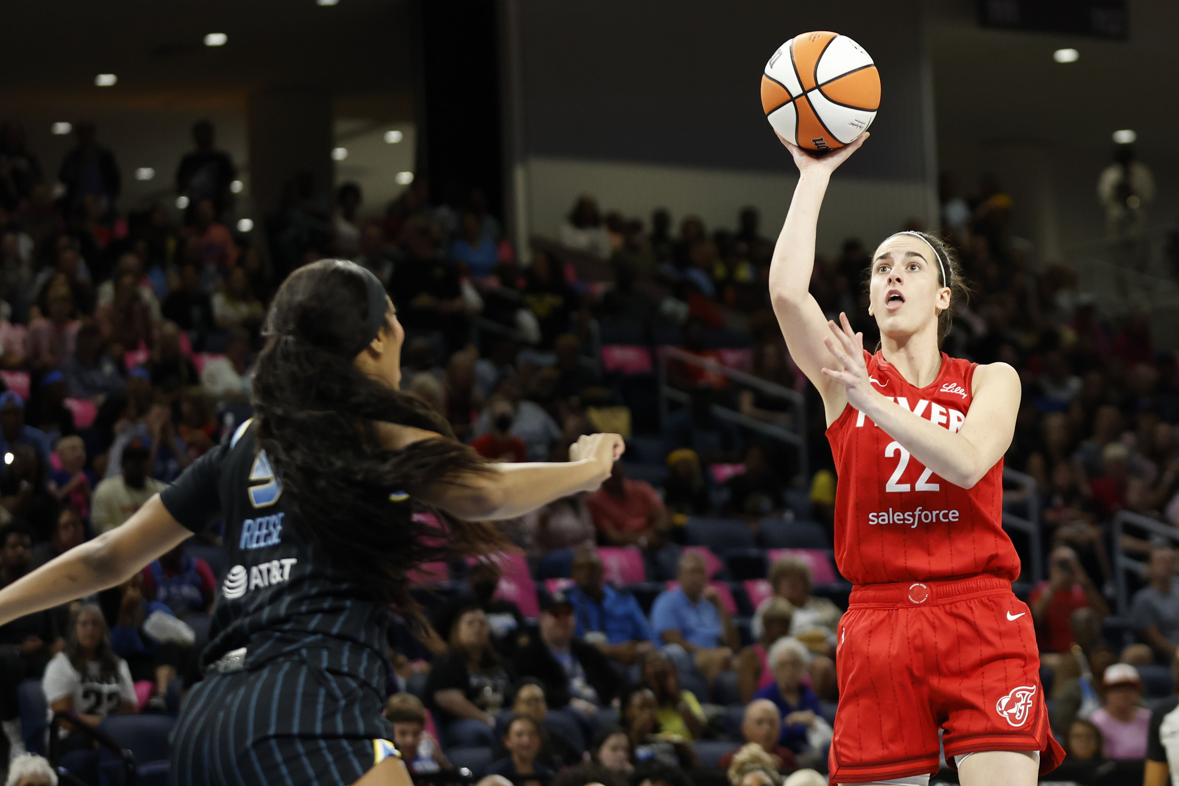 Indiana Fever guard Caitlin Clark shoots against Chicago Sky forward Angel Reese during the first half at Wintrust Arena. Photo Credit: Imagn