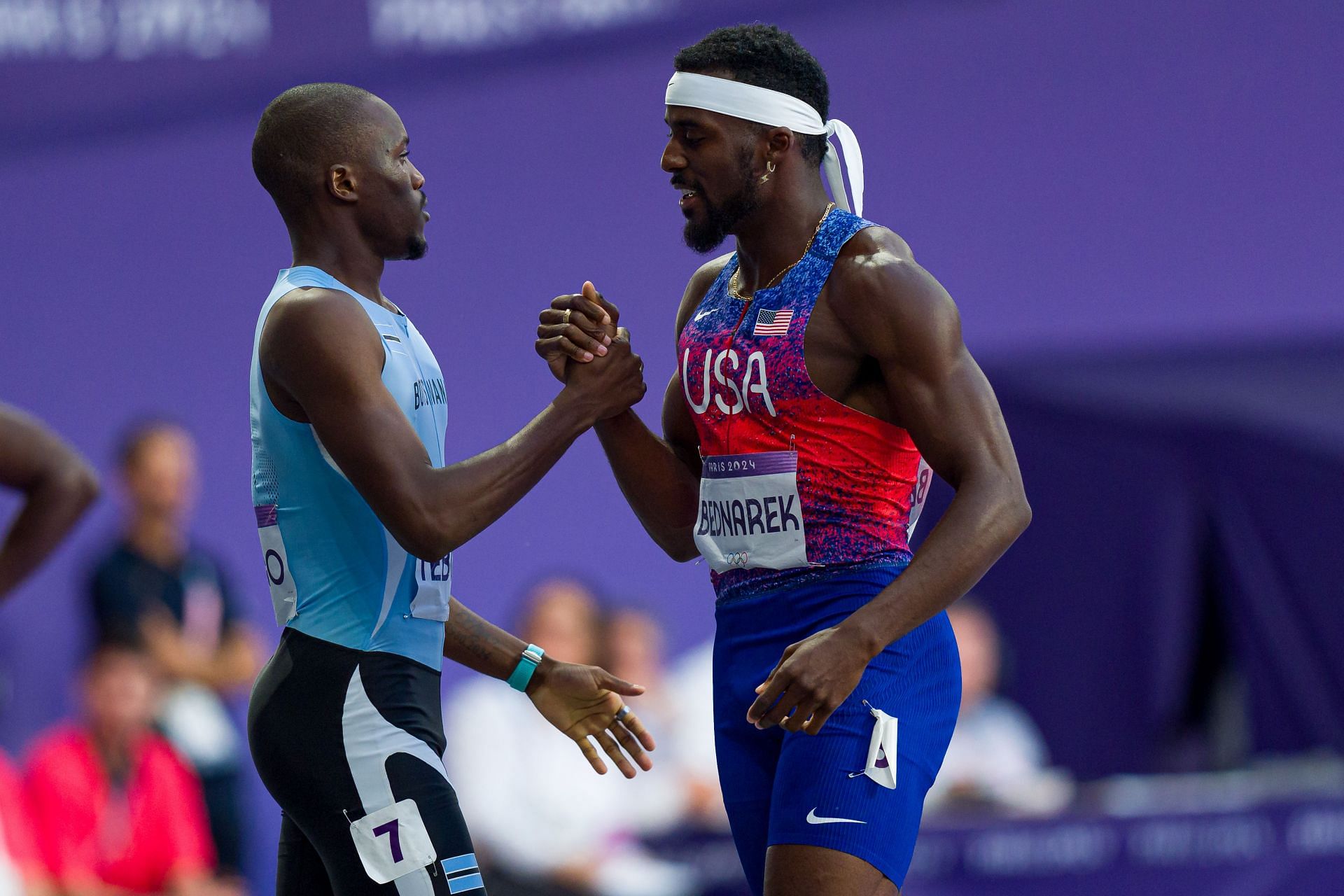 Letsile Tebogo (L) is congratulated by Kenny Bednarek after the finals of the 200m at the 2024 Paris Olympics [Image Source: Getty]