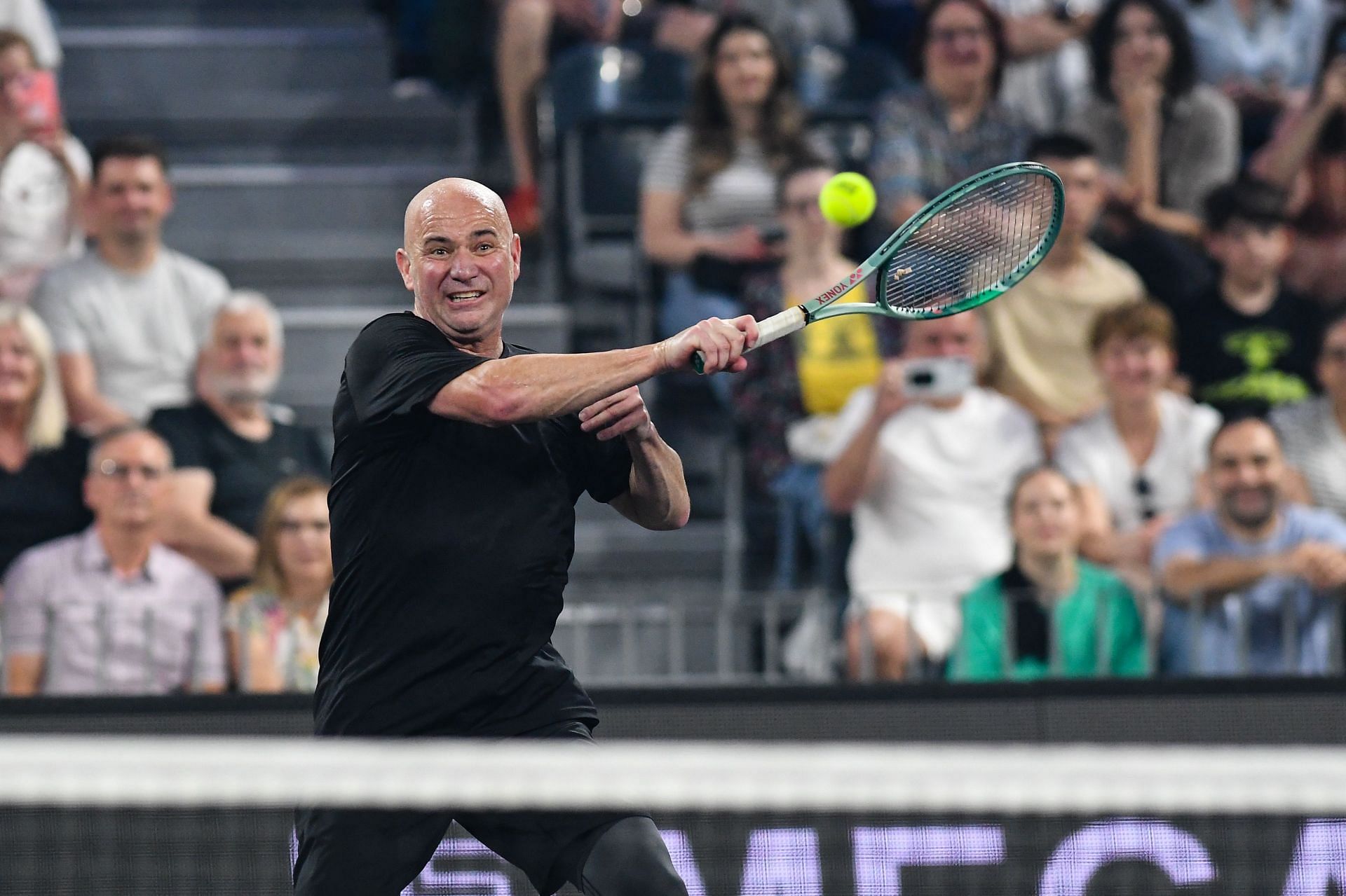 Andre Agassi hits a shot during an exhibition tournament (Image via Getty)