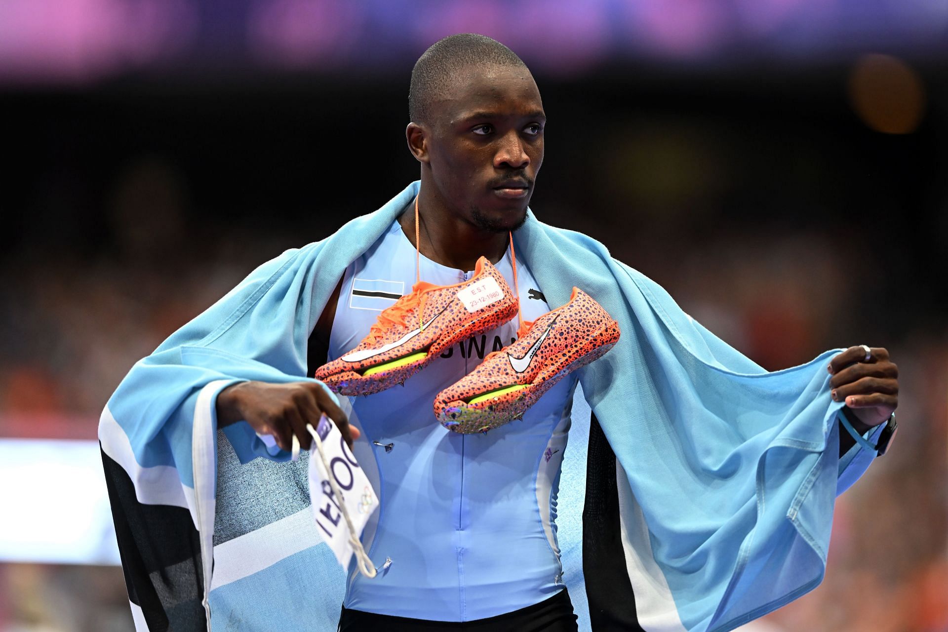 Athletics: Olympic Games Paris 2024: Day 13: Letsile Tebogo holds his shoe in remembrance of late Seratiwa Tebogo (Source: Getty)