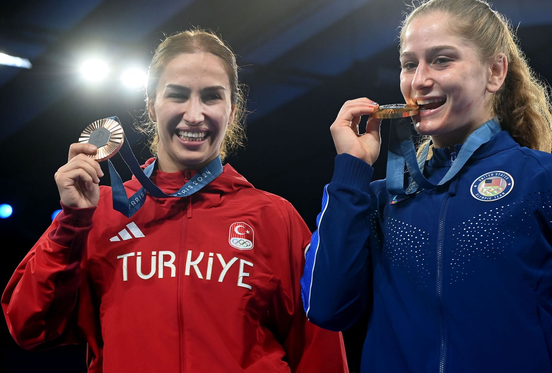 Buse Cavusoglu Tosun of Turkiye (red) and Amit Elor (blue) of the US pose for a photo at the end of the Wrestling Women&#039;s Freestyle 68kg at the Olympic Games 2024 in Paris, France. (Photo via Getty Images)