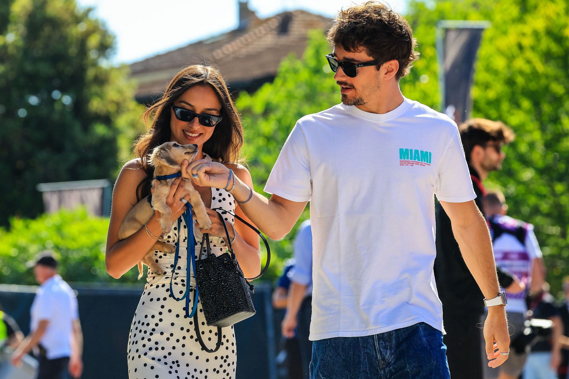 Charles Leclerc of Ferrari and girlfriend Alexandra Saint Mleux arrive in the paddock with Charles&#039; dog Leo. Source: Getty Images