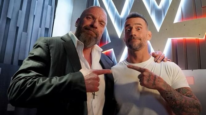 PHOTO: CM Punk shares a moment with Triple H backstage at WWE SummerSlam