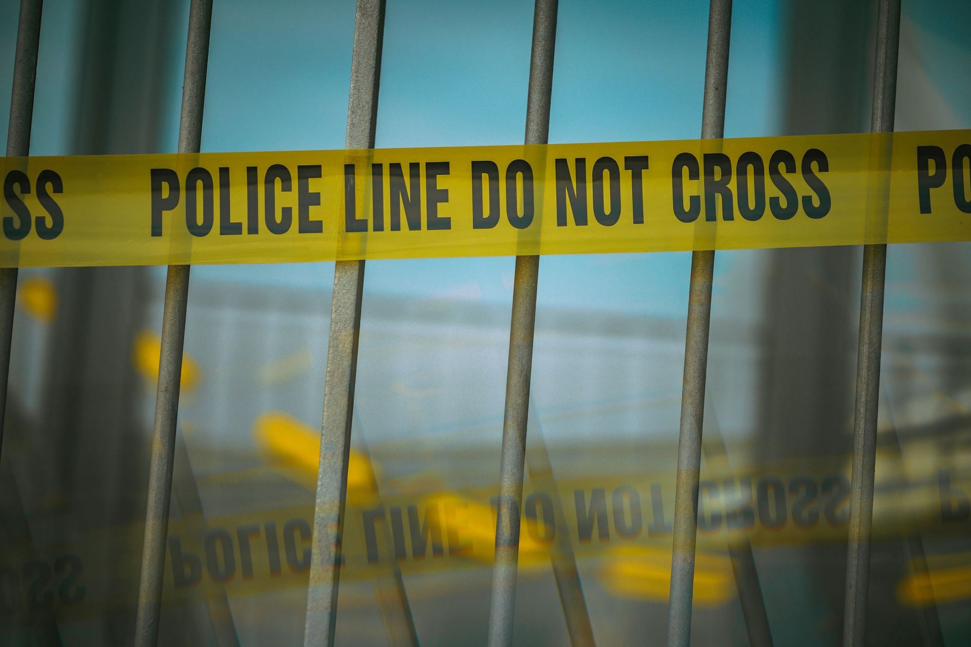 https://unsplash.com/photos/a-close-up-of-a-yellow-police-line-behind-bars-WW-4bspunFY