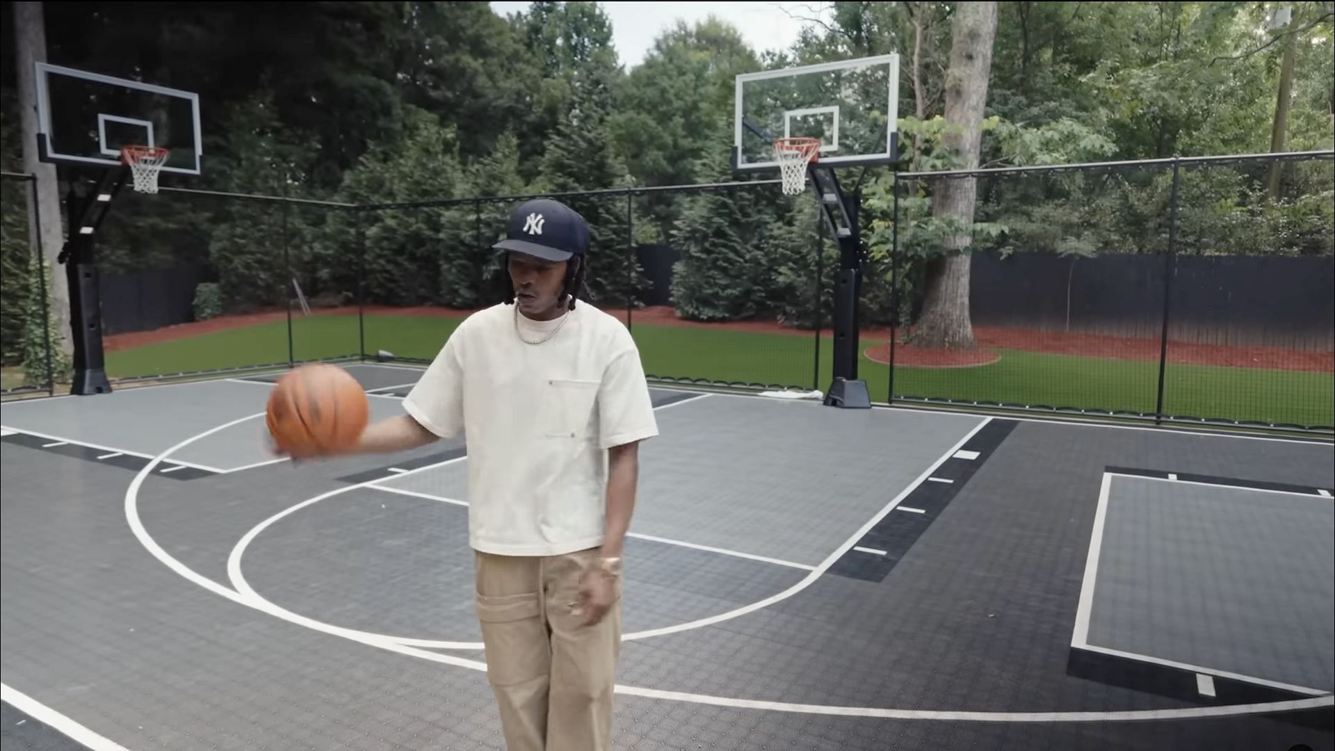 Lil Baby playing basketball in his new Atlanta &quot;Bachelor Pad&quot; (Image via YouTube/@Archdigest)