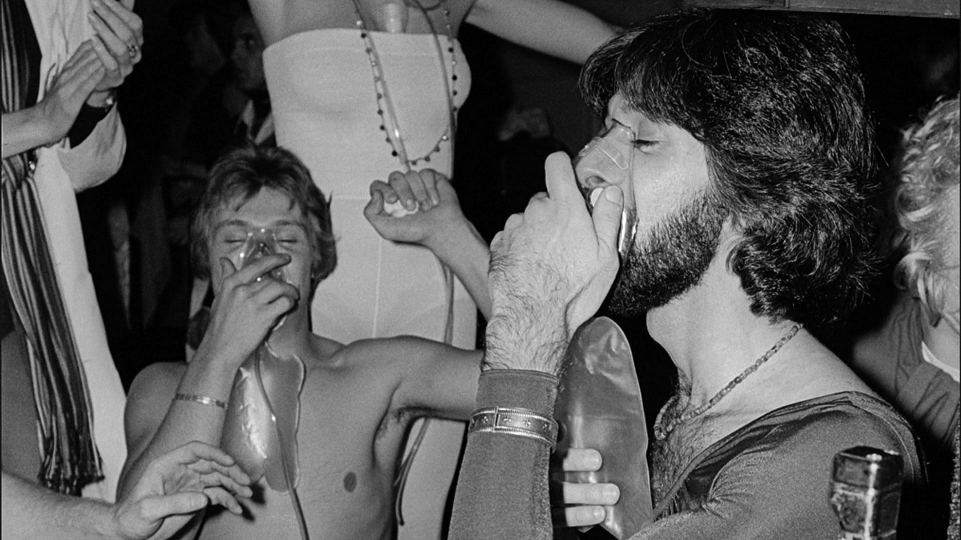 Clubgoers inhale nitrous oxide (also known as laughing gas) on the dance floor during the first annual Halloween party at Studio 54, New York, New York, October 31, 1977 (Photo by Allan Tannenbaum/Getty Images)