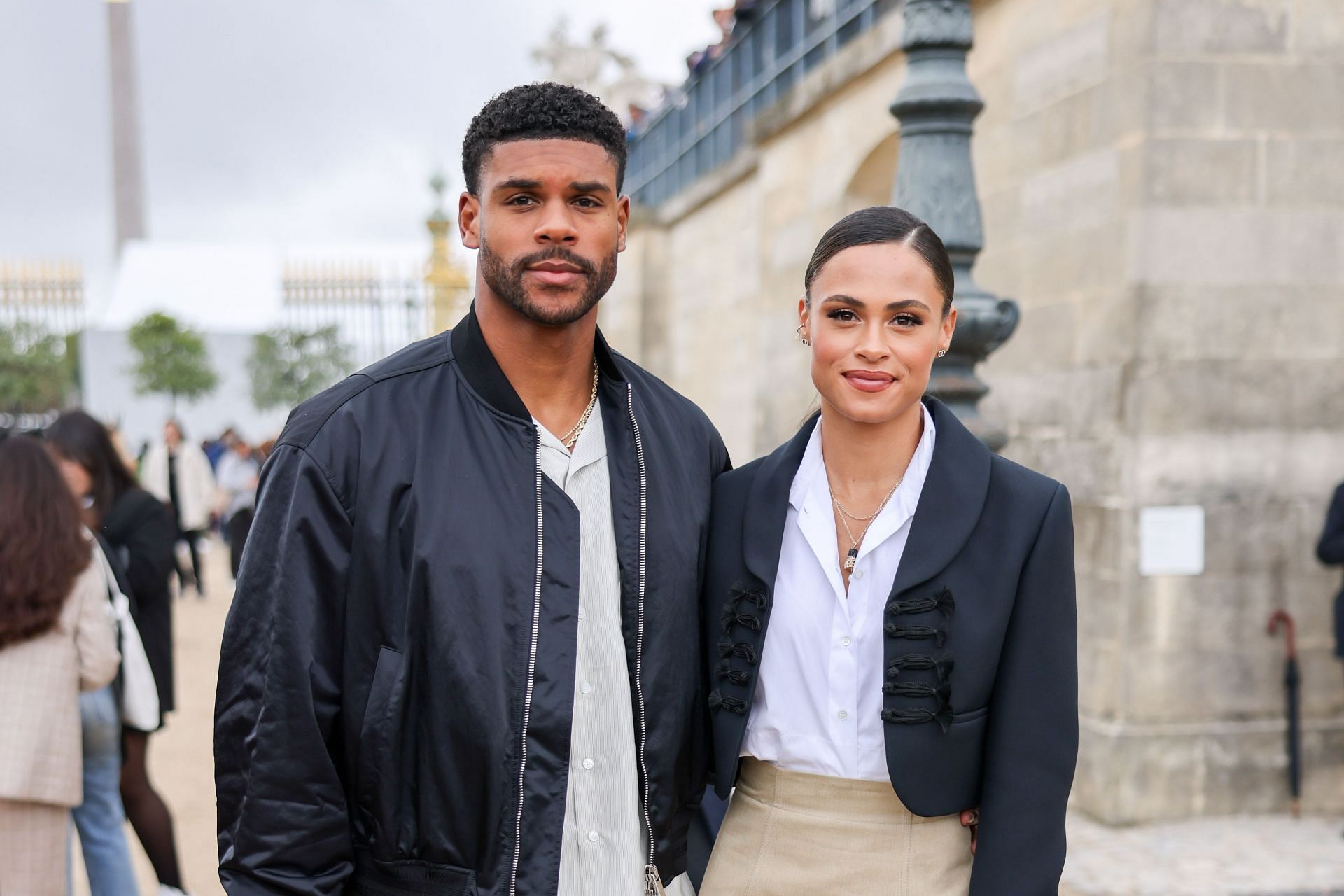 Sydney Mclaughlin Levrone and her husband Andre Levrone attending the Christian Dior : Outside Arrivals - Paris Fashion Week - Womenswear Spring/Summer 2023 [Image Source: Getty]