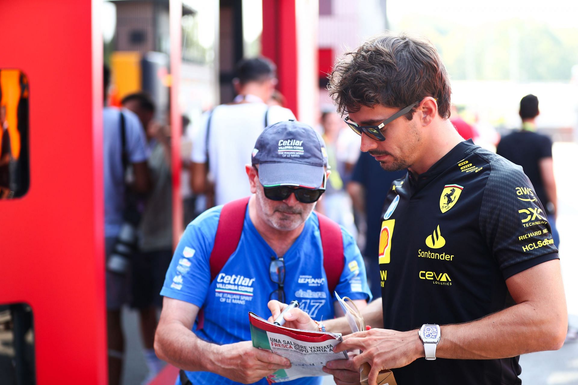 Charles Leclerc of Ferrari with a fan during previews ahead of the Italian GP. Source: Getty Images.