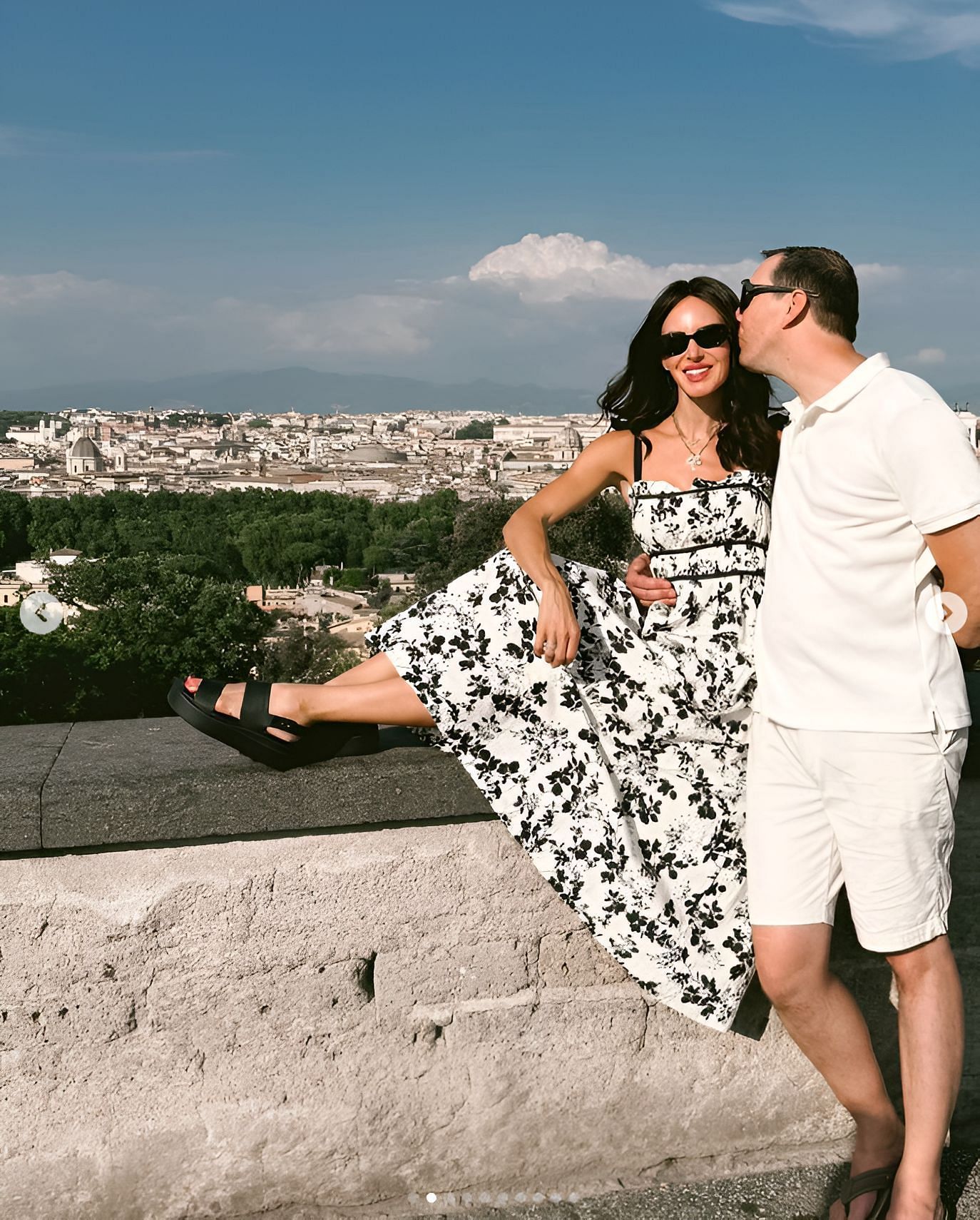 Samantha in a flowing black-and-white floral print maxi dress from Shein and Brooklyn Low Wedge Crocs, along with Kyle Busch (IMAGE: Instagram, Samantha Busch)